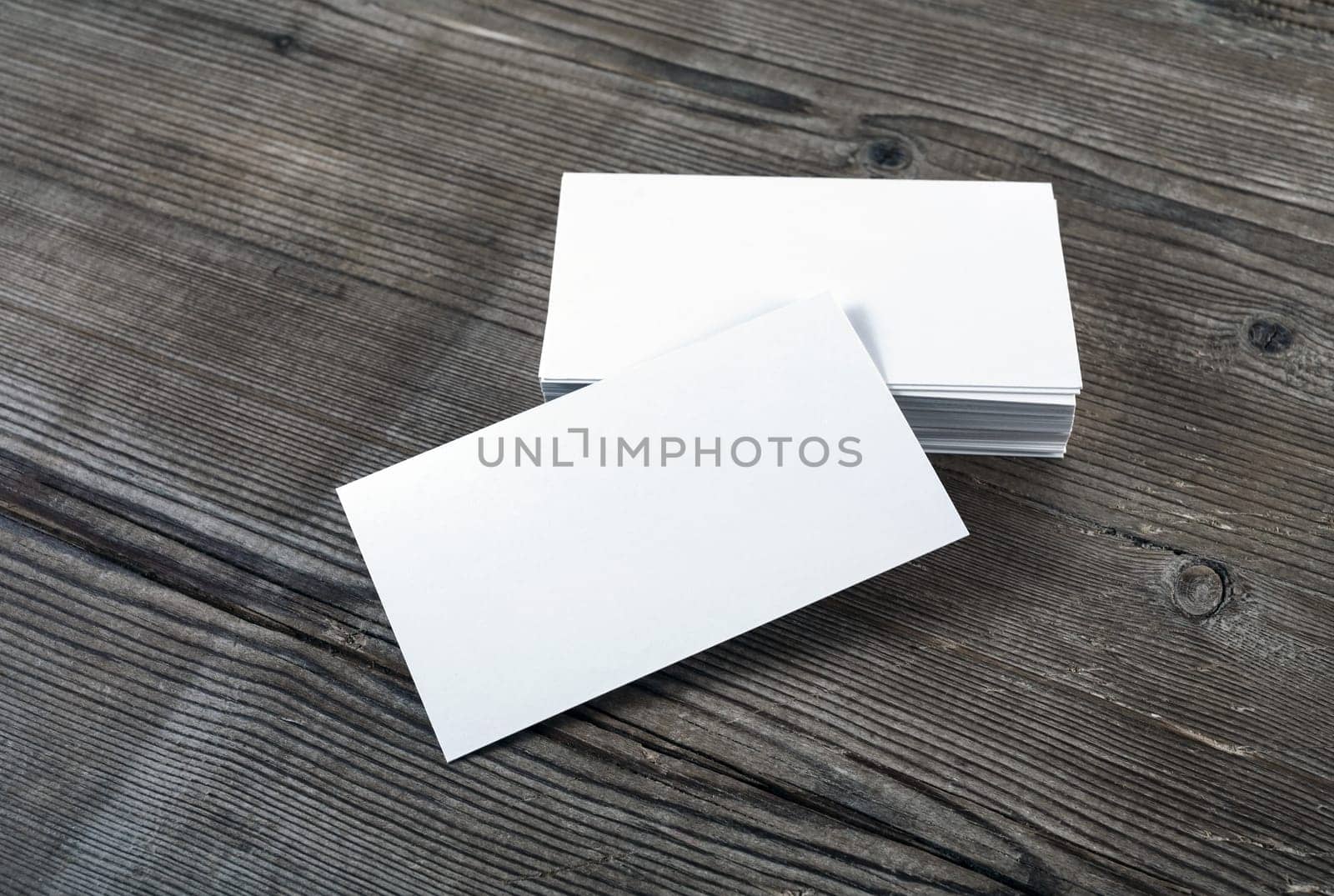 Blank business cards on a wooden table background for placing your design. Template for ID.