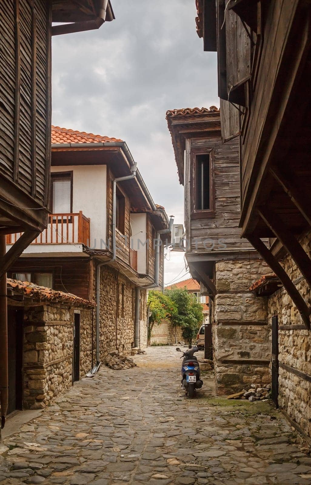 Nesebar, Bulgaria - September 08, 2014: Narrow street and ancient architecture in the old town of Nessebar, Bulgaria. Nesebar is an ancient town on the Bulgarian Black Sea Coast. Vertical shot.