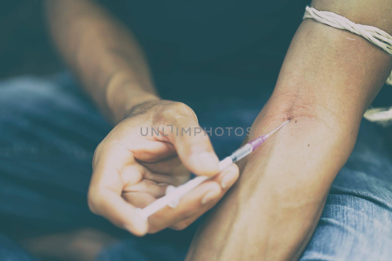drug addict man with syringe in action