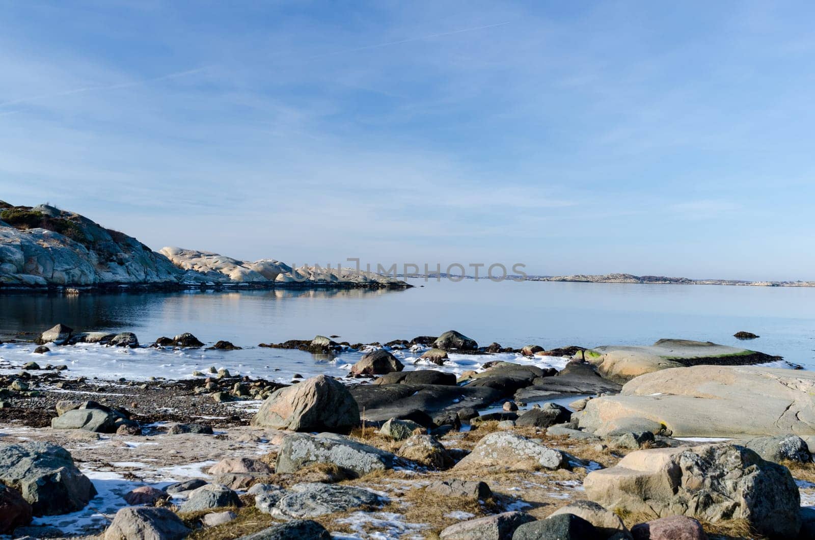 the sun is shining over the water on the swedish westcoast with all the rocks