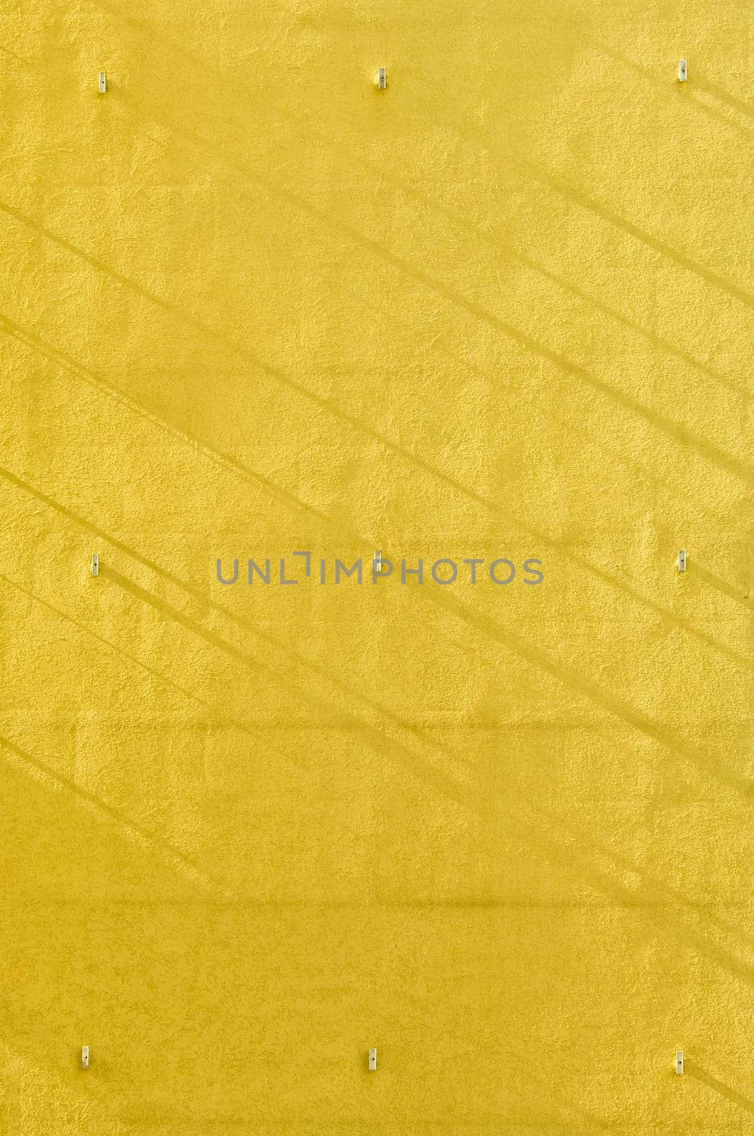 Yellow wall background with narrow shadow strips