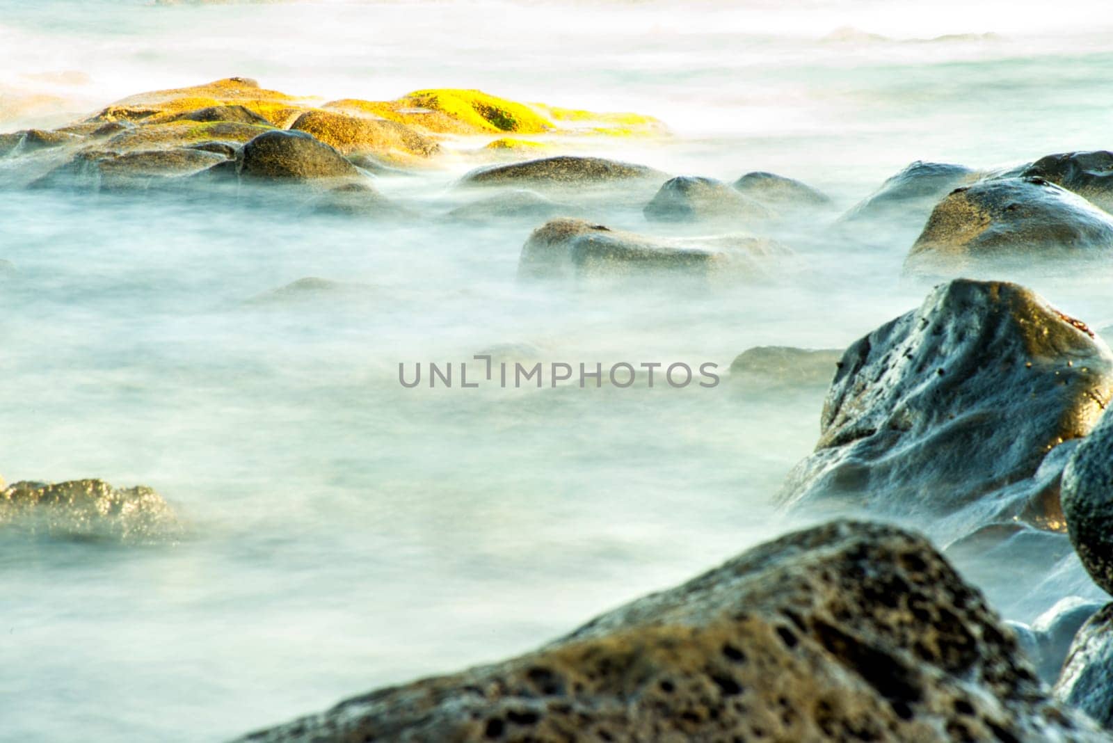 Surf of the Atlantic Ocean with rocks in long exposure