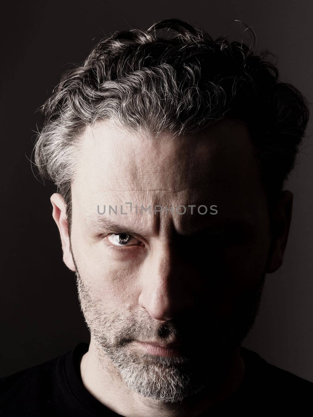 Different sides of a man, portrait with one studio light