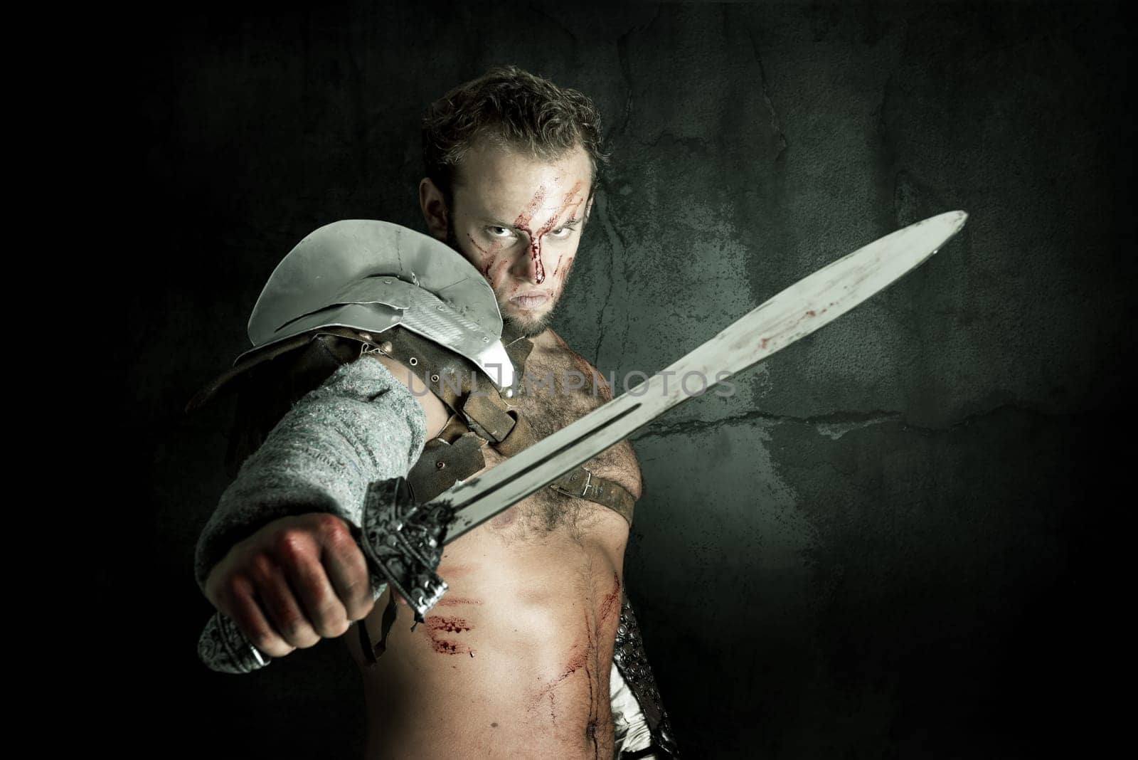 Ancient warrior or Gladiator posing against a dark background with sword