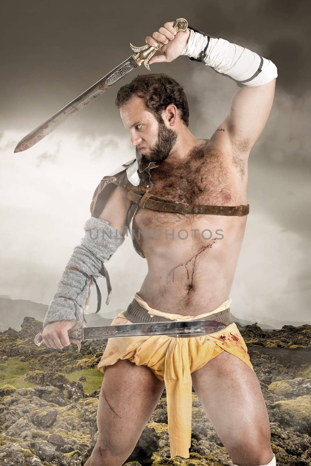 Ancient warrior or Gladiator posing outdoors with swords