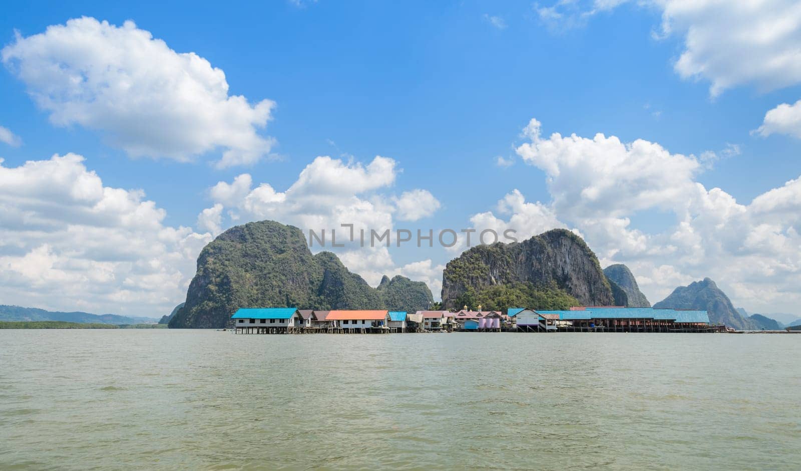 Landscape of limestone karsts of Phang Nga Bay National Park. Panyi island or Koh Panyee, floating fishing village in Phang Nga Province, Thailand