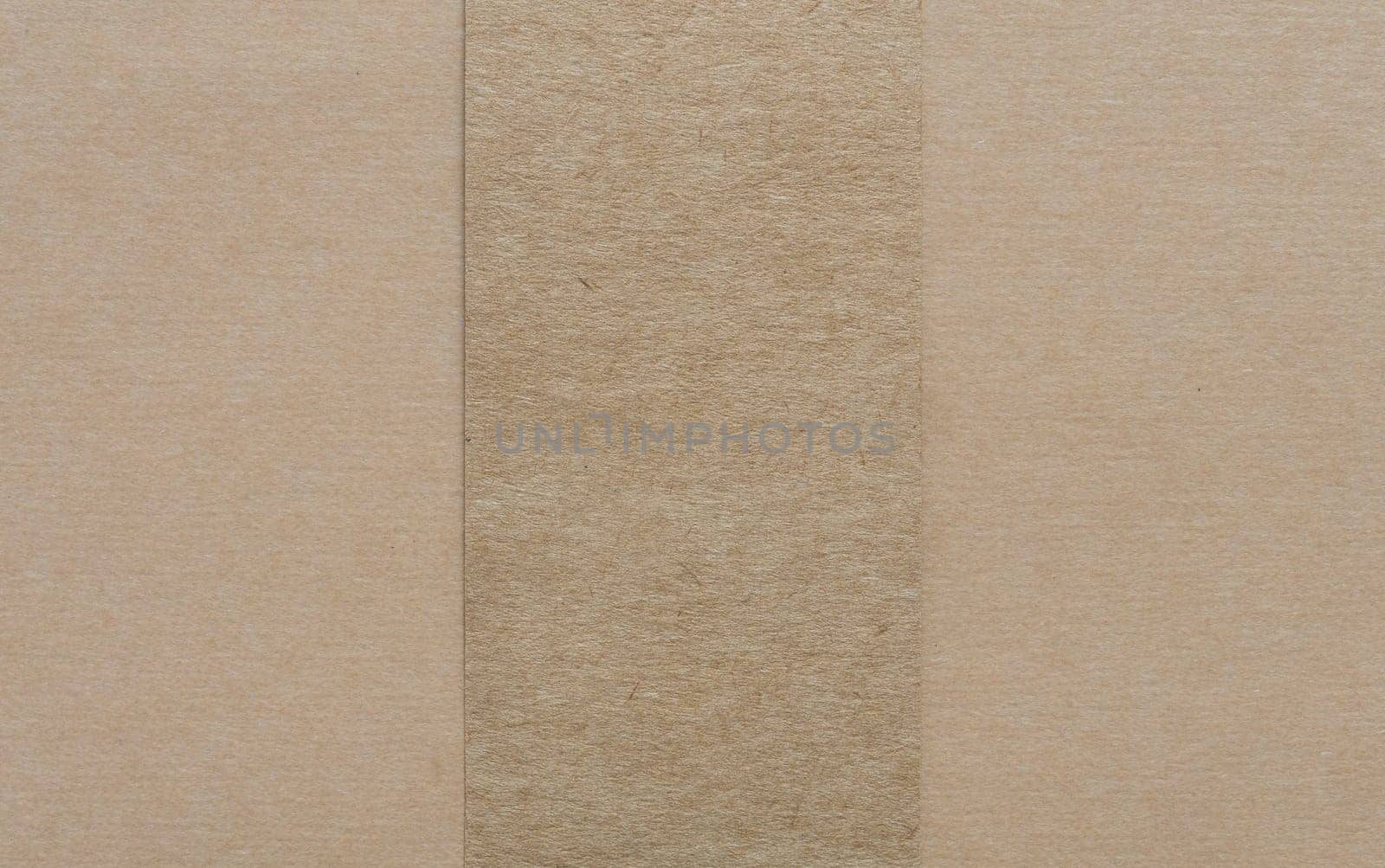 Blank dark brown paper on light brown cardboad background