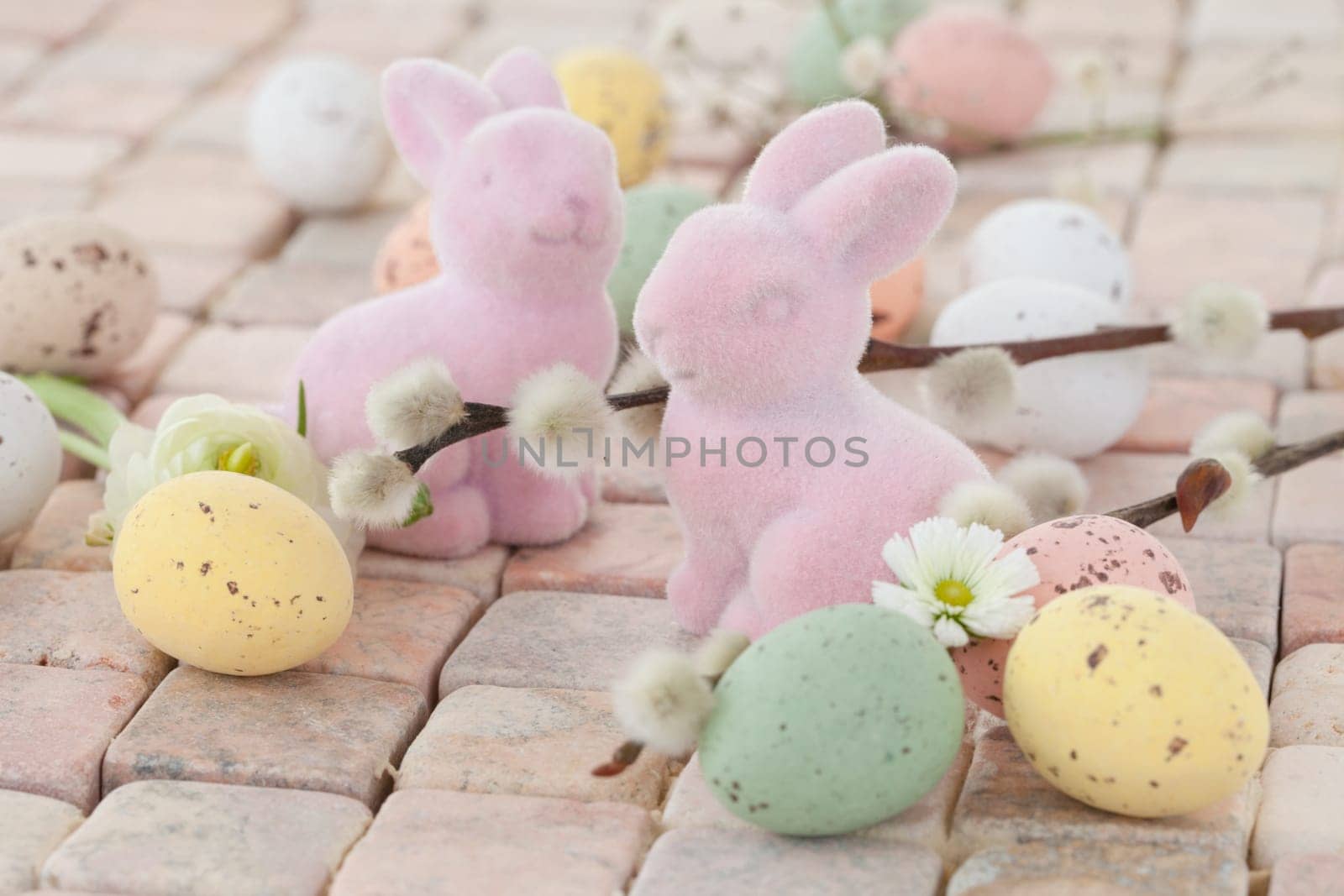 Little pink Easter bunnies and colorful Easter eggs