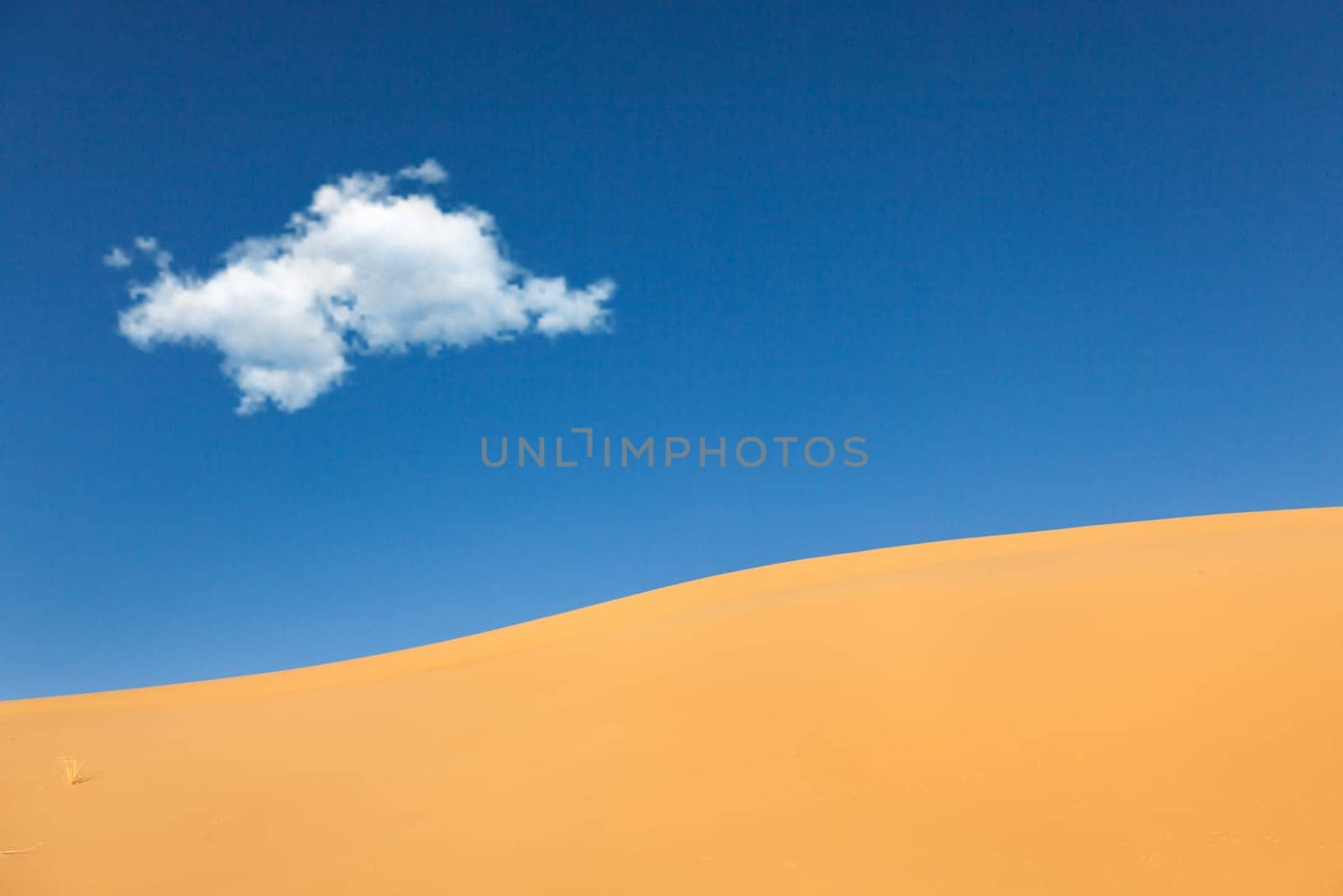 Desert  Sand dunes with white cloud in blue sky