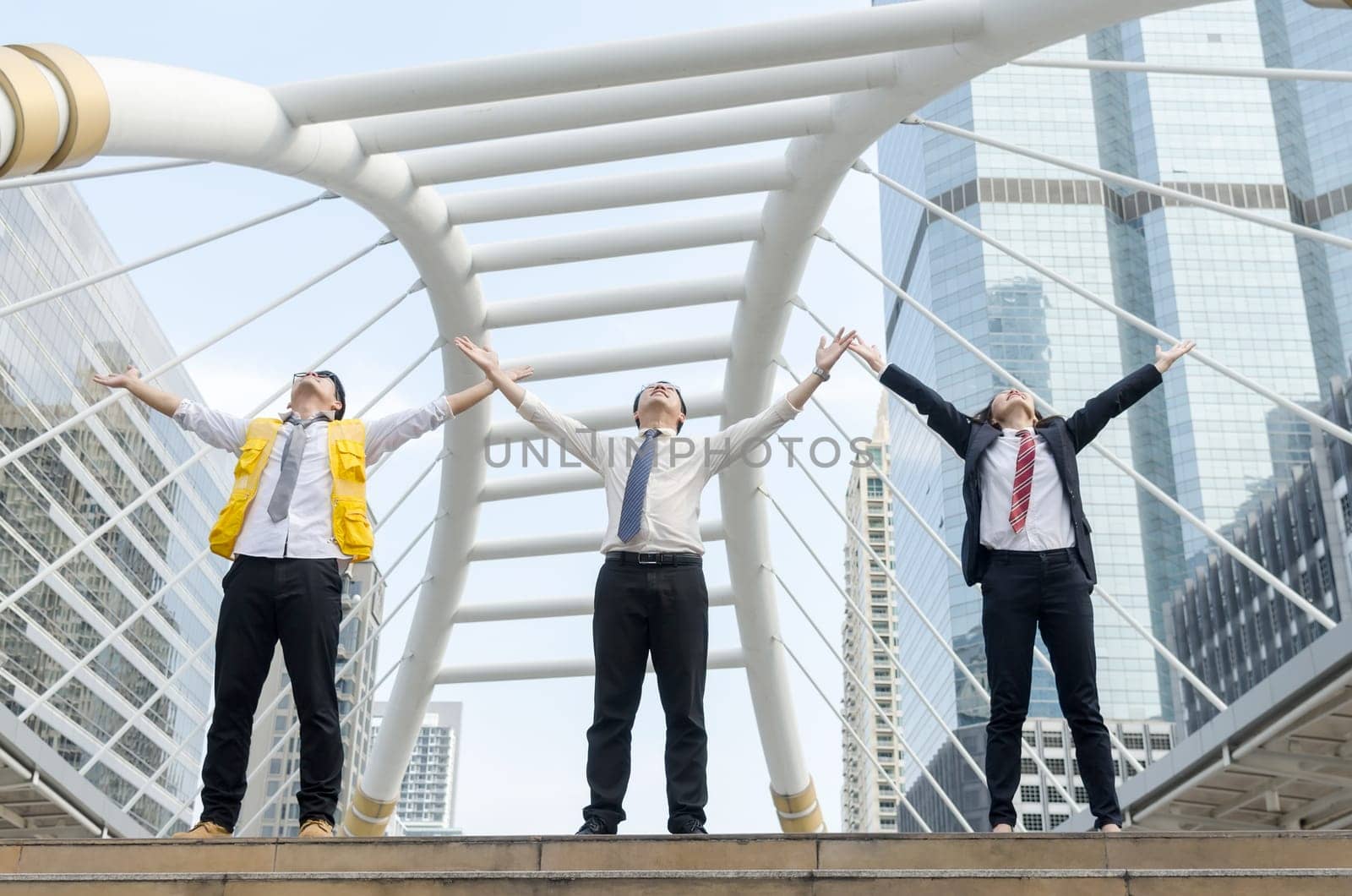 Success concept. Asian businessman jumping with with happy moment and modern building background.