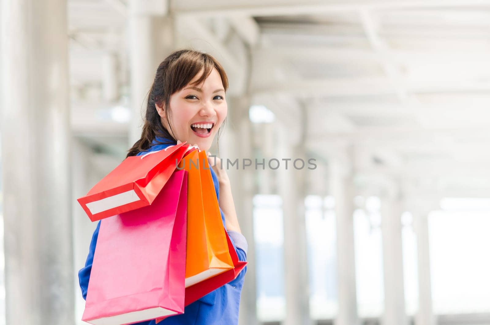 Beautiful young asia woman with shopping bags. Happiness, consumerism, sale concept.