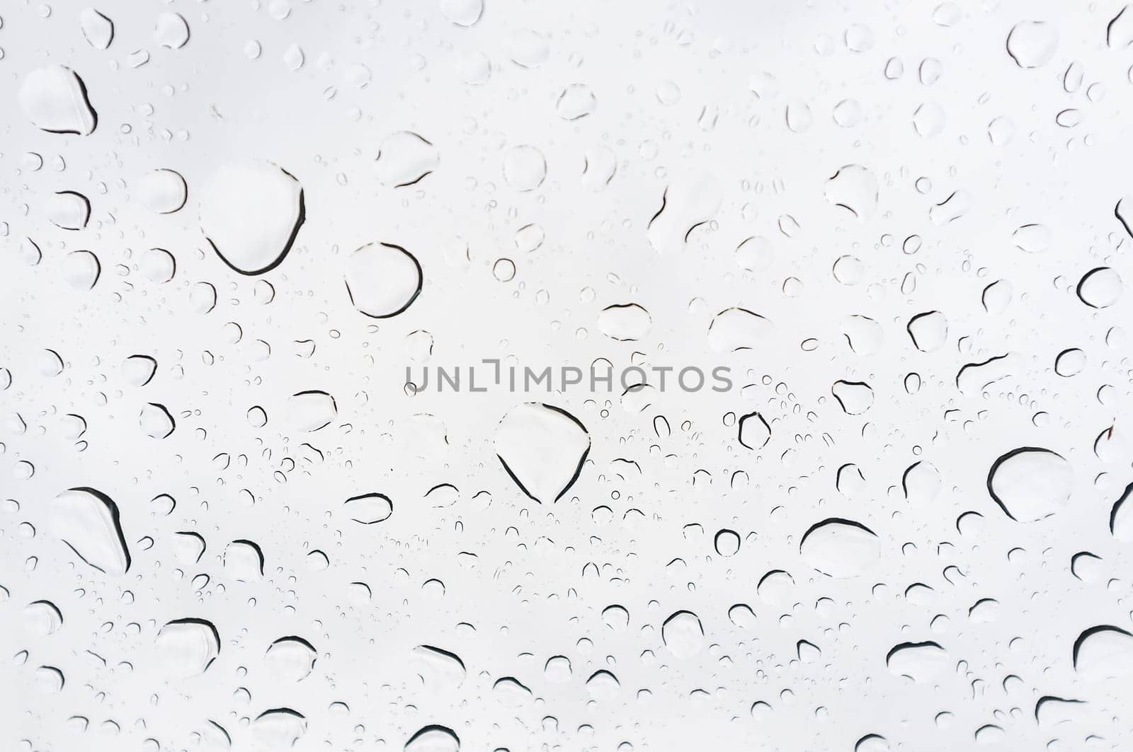 Drops of rain on glass, rain drops on clear window.