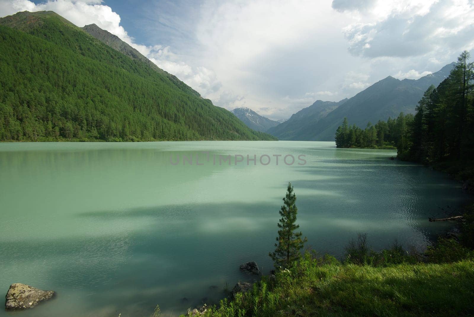 Beautiful mountain landscape near the lake. Mountain Lake. Kind of mountainous terrain and the water in the valley.
