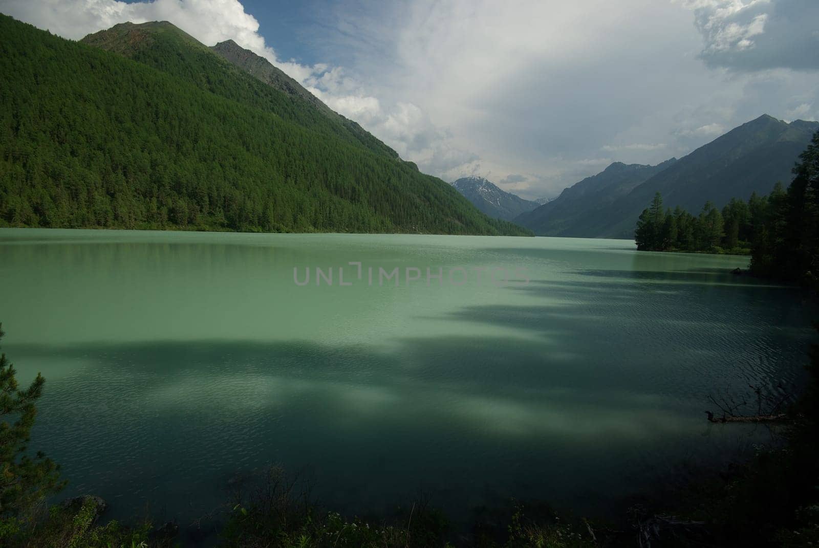 Beautiful mountain landscape near the lake. Mountain Lake. Kind of mountainous terrain and the water in the valley.