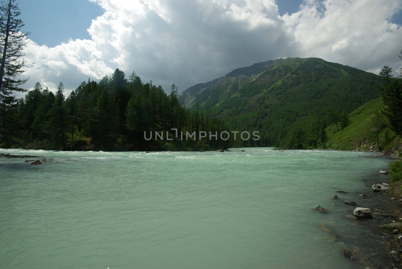 Beautiful mountain landscape near the lake. Mountain Lake. Kind of mountainous terrain and the water in the valley.