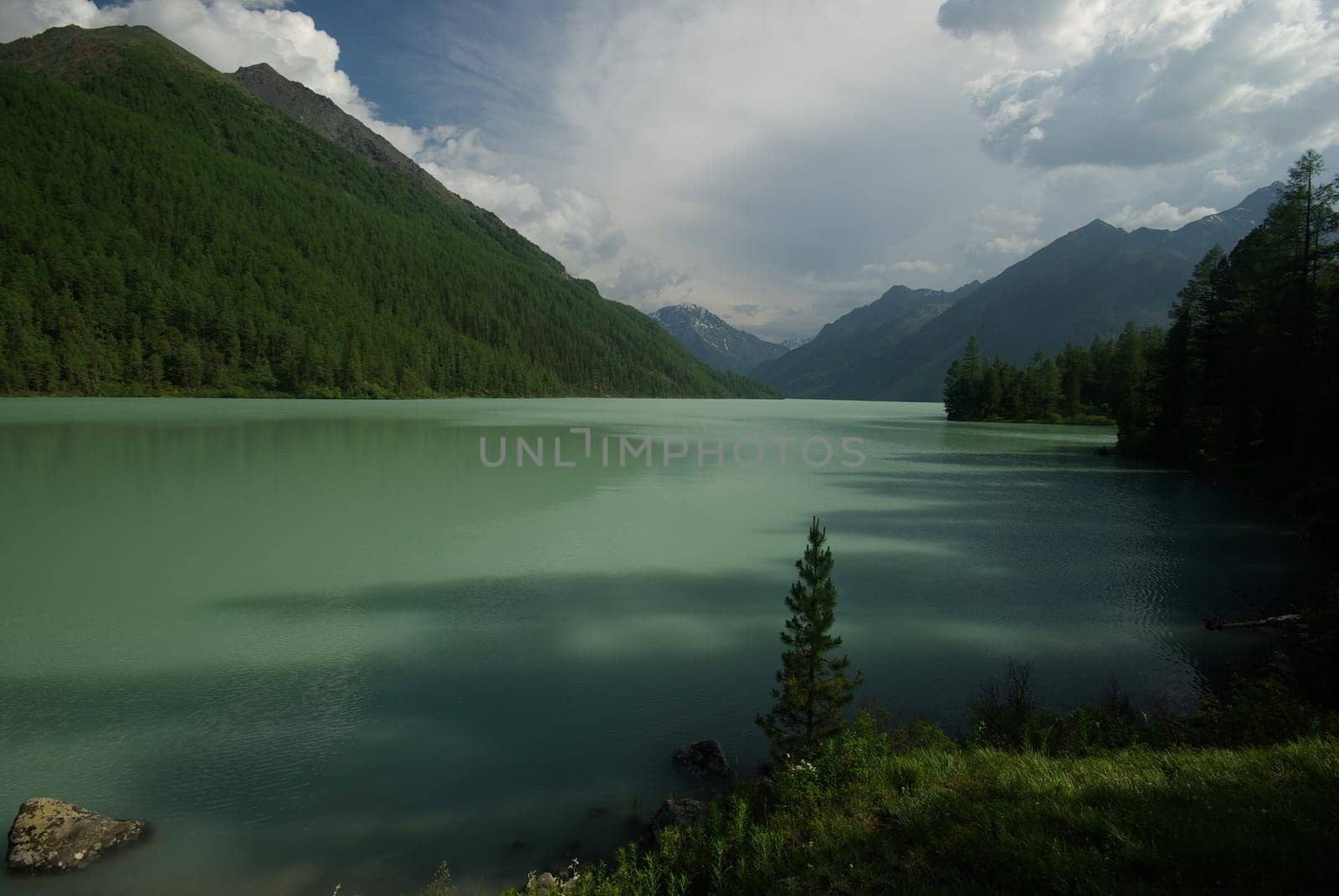 Beautiful mountain landscape near the lake. Mountain Lake. Kind of mountainous terrain and the water in the valley.