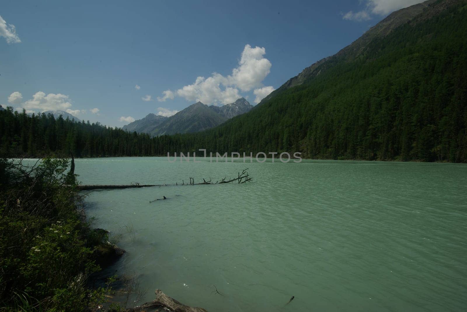Beautiful mountain landscape near the lake. Mountain Lake. Kind of mountainous terrain and the water in the valley.
