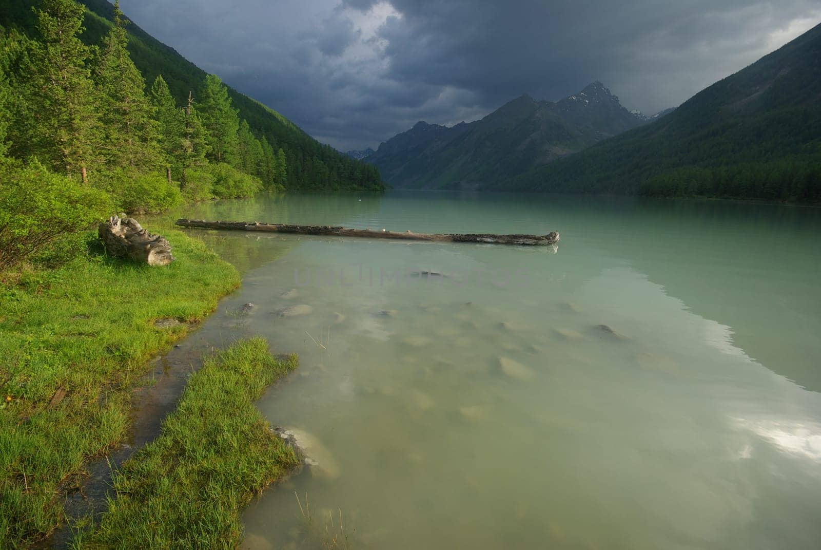 Beautiful mountain landscape near the lake. Mountain Lake. Kind of mountainous terrain and the water in the valley.