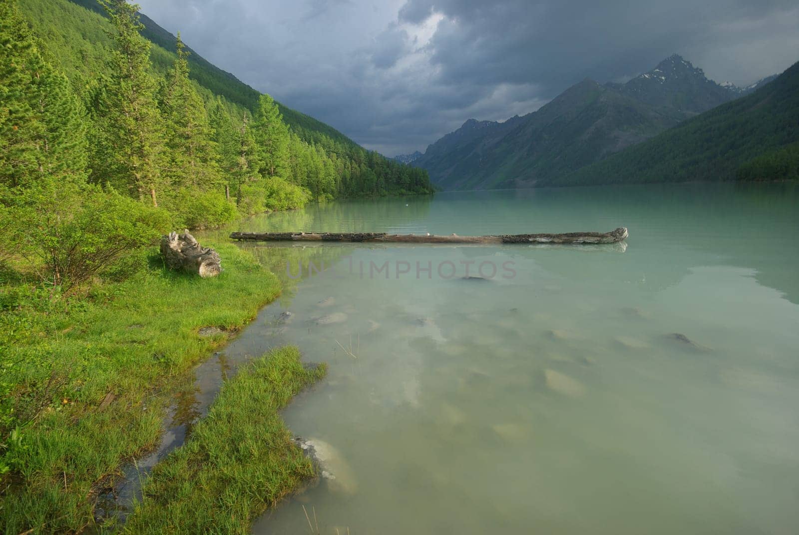 Beautiful mountain landscape near the lake. Mountain Lake. Kind of mountainous terrain and the water in the valley.
