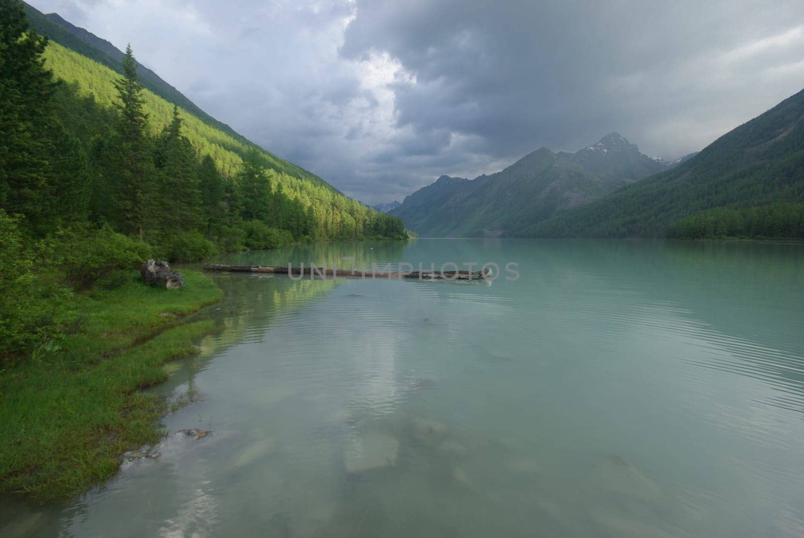 Beautiful mountain landscape near the lake. Mountain Lake. Kind of mountainous terrain and the water in the valley.