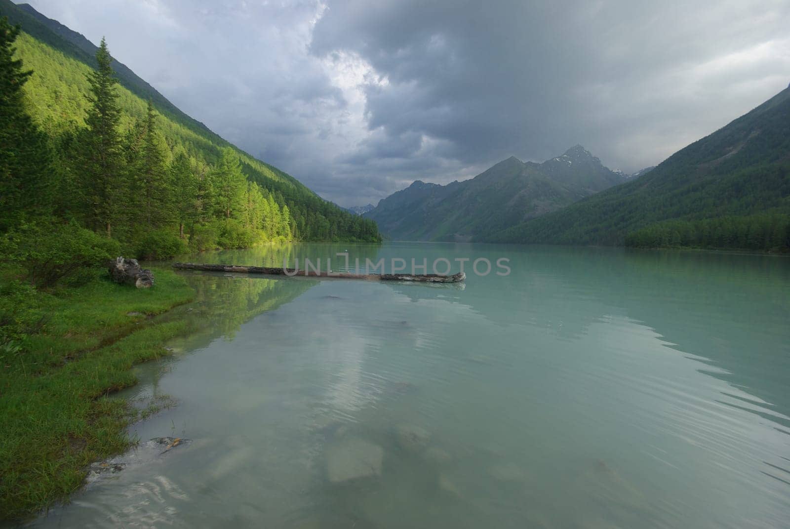 Beautiful mountain landscape near the lake. Mountain Lake. Kind of mountainous terrain and the water in the valley.