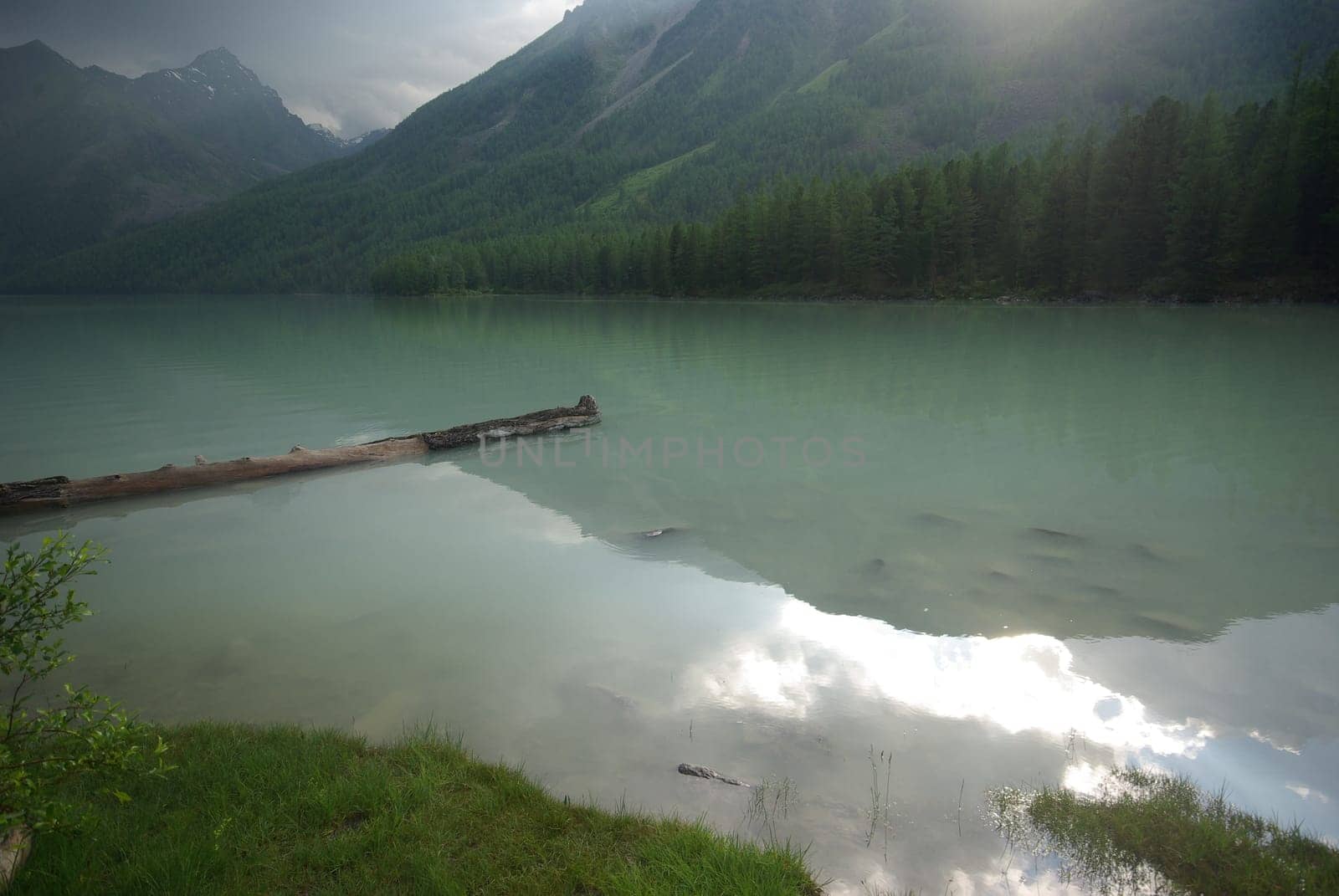 Beautiful mountain landscape near the lake. Mountain Lake. Kind of mountainous terrain and the water in the valley.