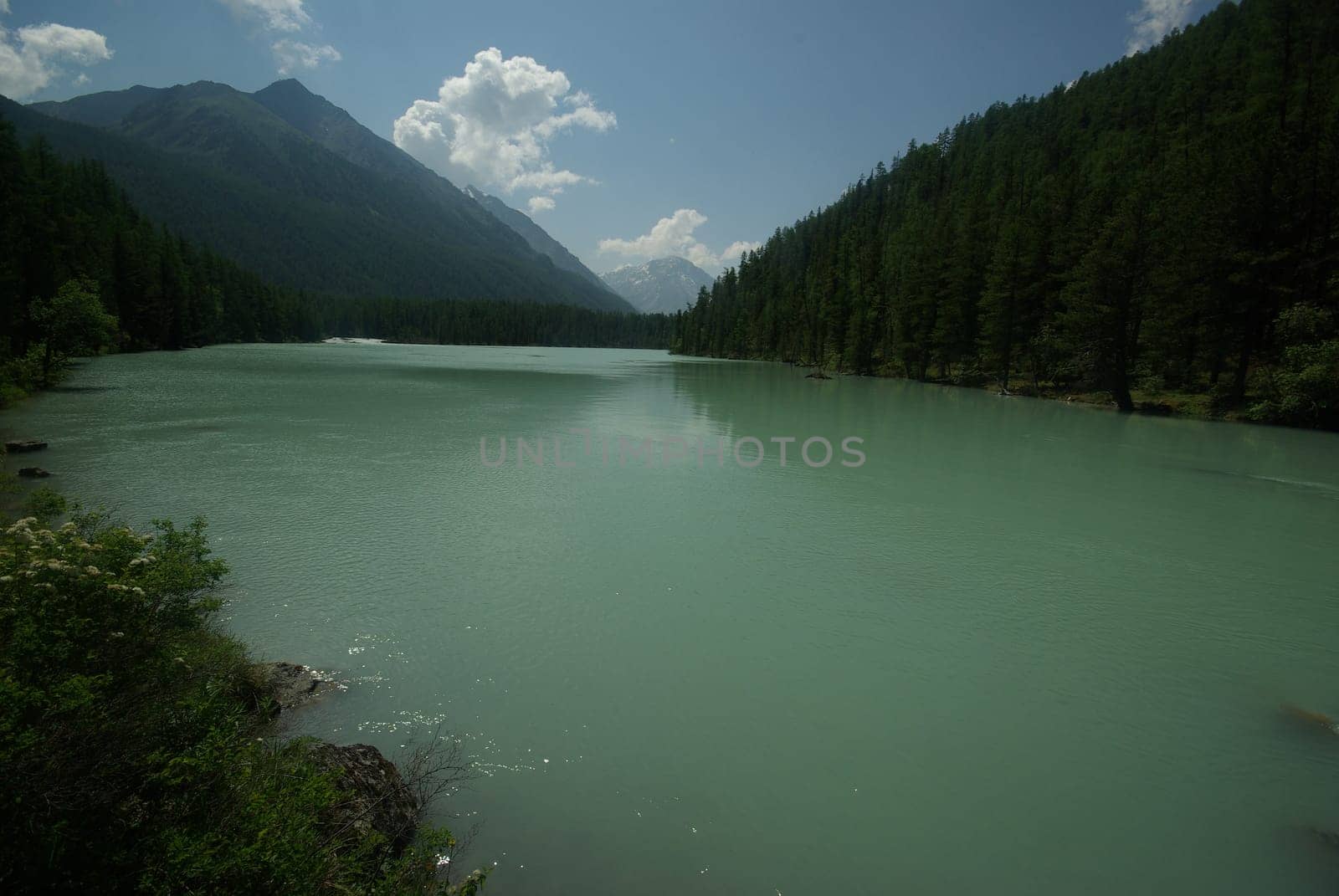 Beautiful mountain landscape near the lake. Mountain Lake. Kind of mountainous terrain and the water in the valley.