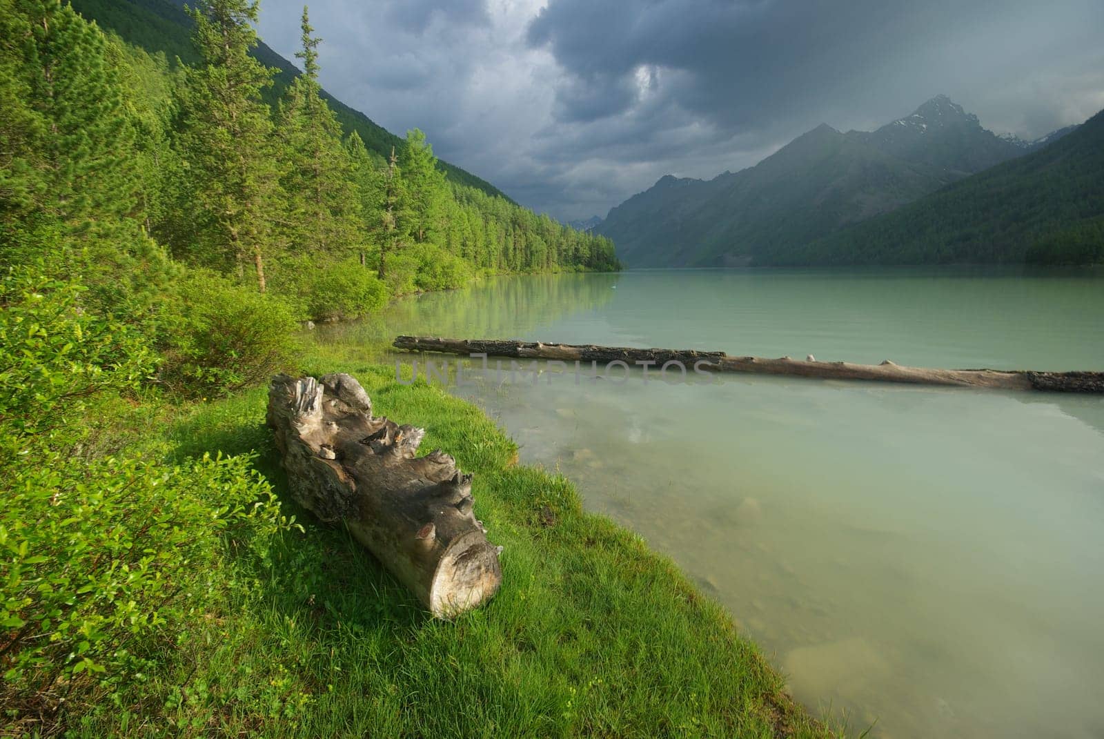 Beautiful mountain landscape near the lake. Mountain Lake. Kind of mountainous terrain and the water in the valley.