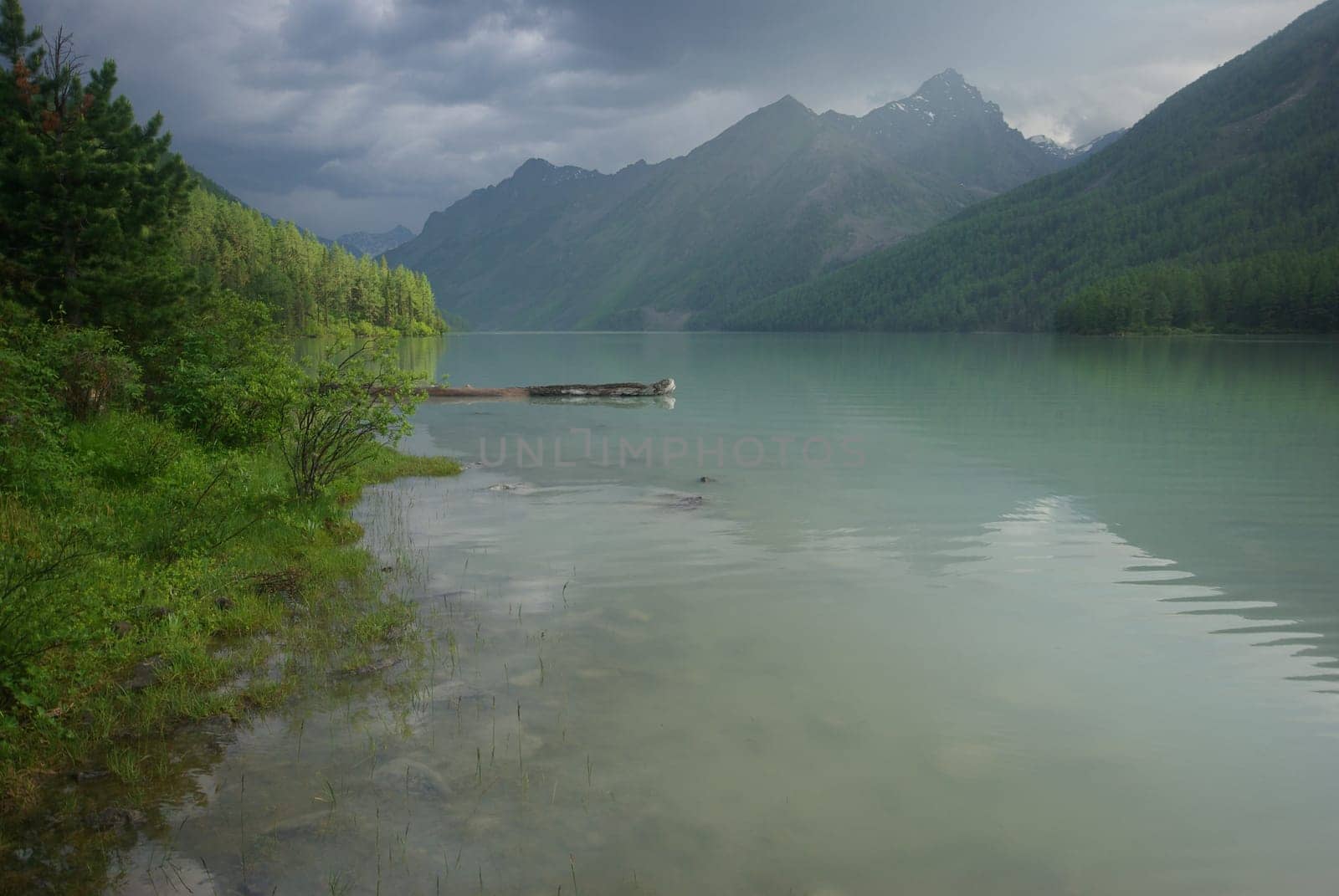 Beautiful mountain landscape near the lake. Mountain Lake. Kind of mountainous terrain and the water in the valley.