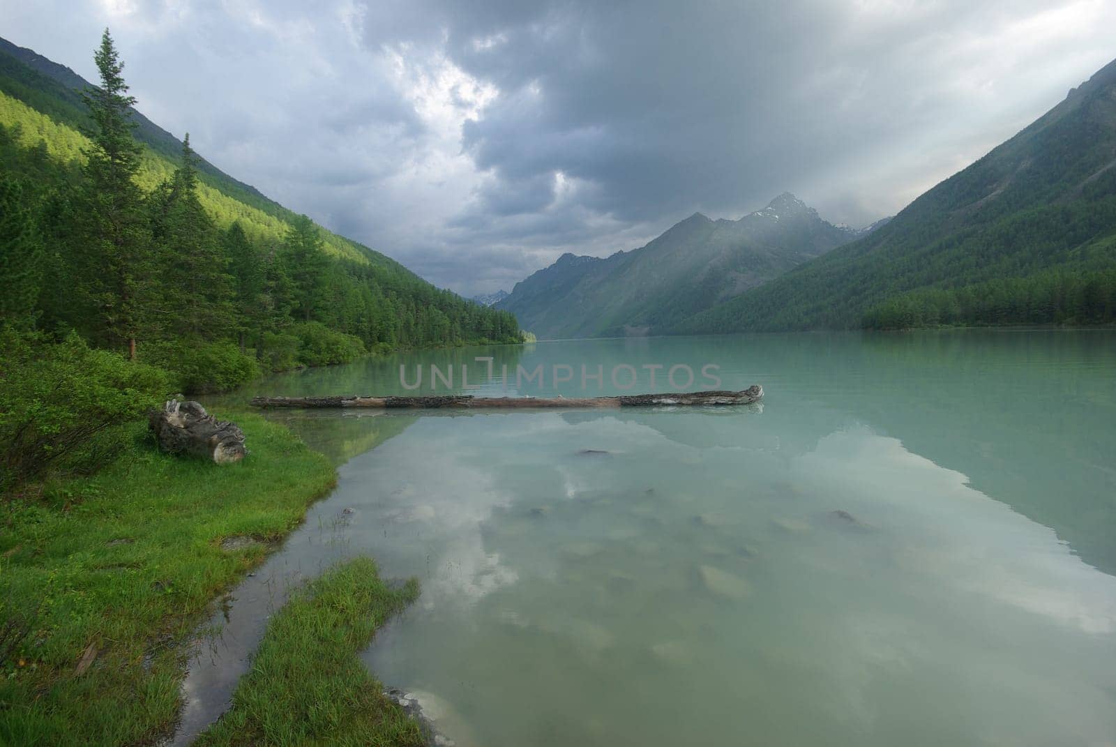 Beautiful mountain landscape near the lake. Mountain Lake. Kind of mountainous terrain and the water in the valley.