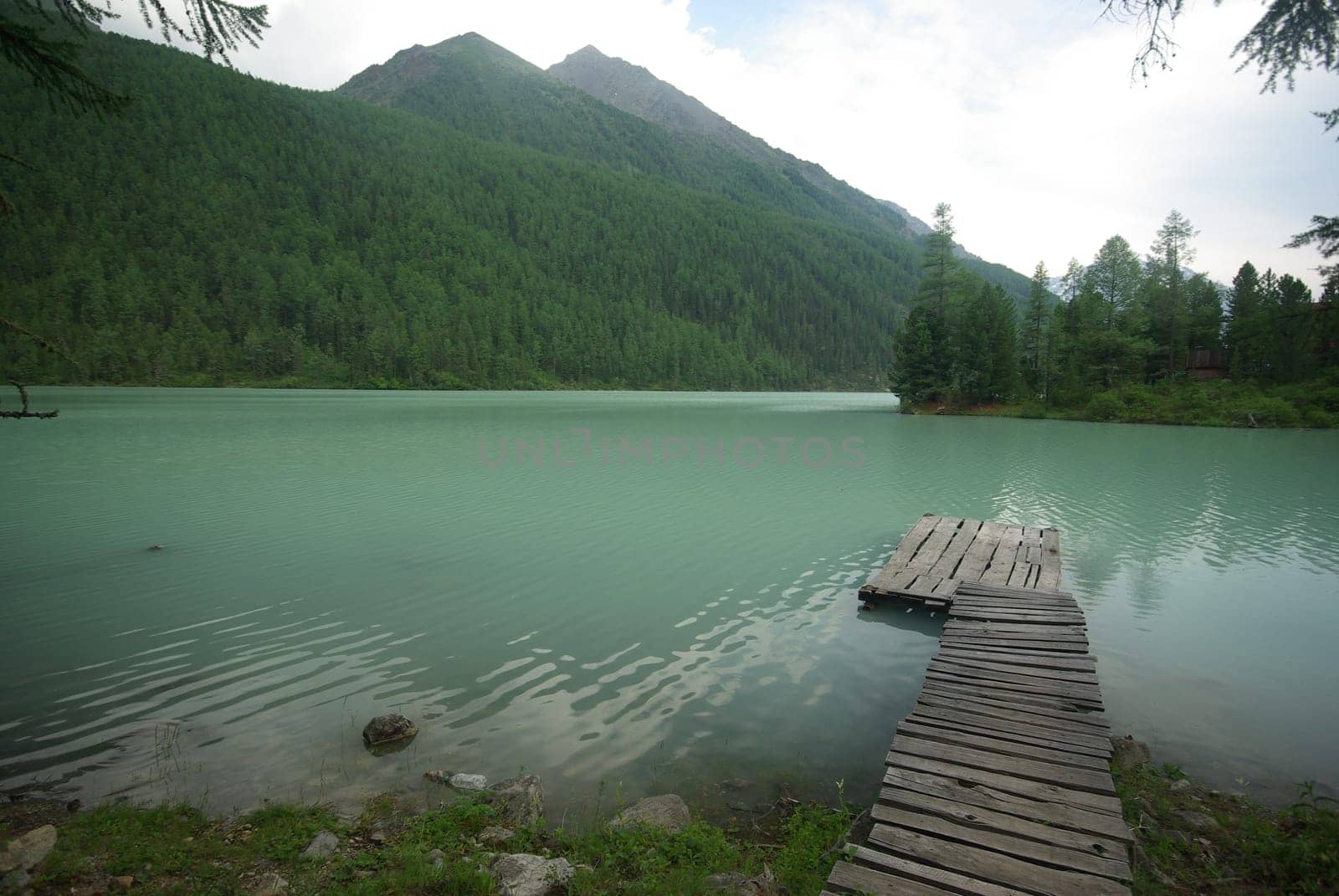 Beautiful mountain landscape near the lake. Mountain Lake. Kind of mountainous terrain and the water in the valley.