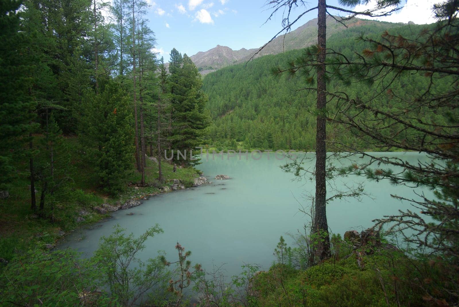 Beautiful mountain landscape near the lake. Mountain Lake. Kind of mountainous terrain and the water in the valley.