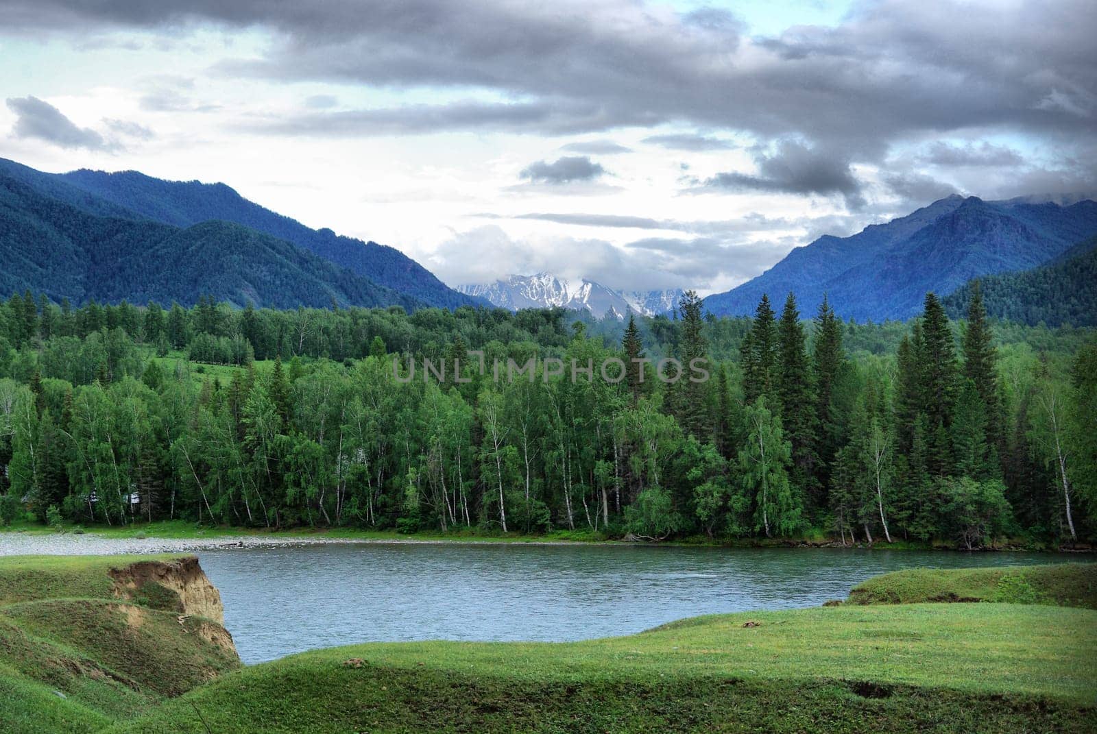 Beautiful mountain landscape near the lake. Mountain Lake. Kind of mountainous terrain and the water in the valley.