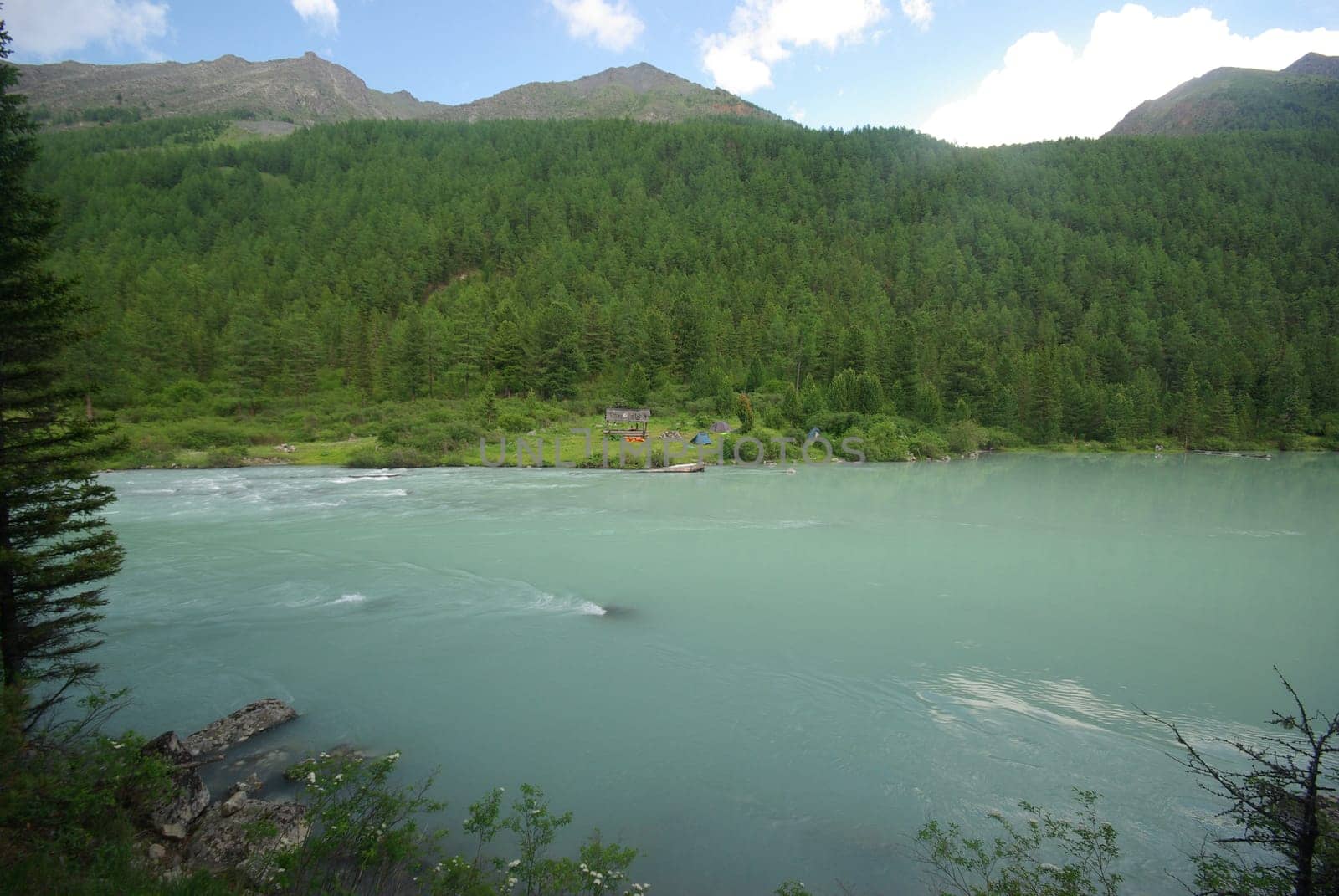 Beautiful mountain landscape near the lake. Mountain Lake. Kind of mountainous terrain and the water in the valley.