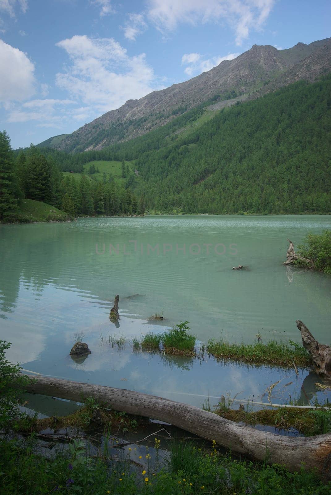 Beautiful mountain landscape near the lake. Mountain Lake. Kind of mountainous terrain and the water in the valley.