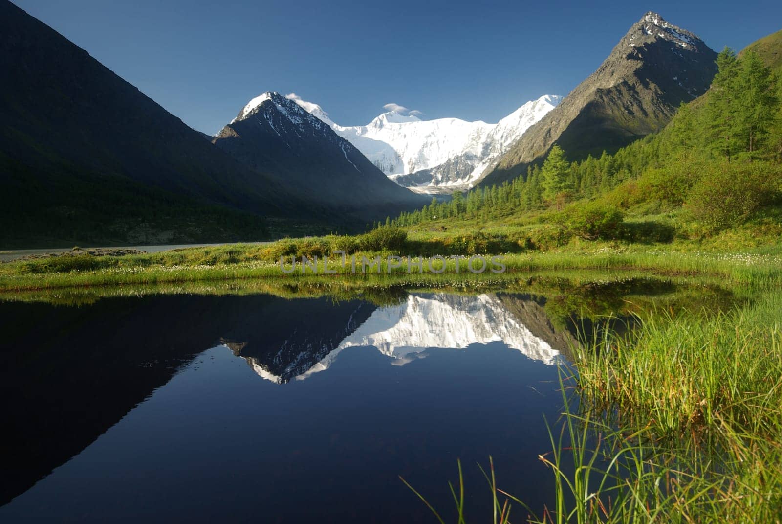 Beautiful mountain landscape near the lake. Mountain Lake. Kind of mountainous terrain and the water in the valley.
