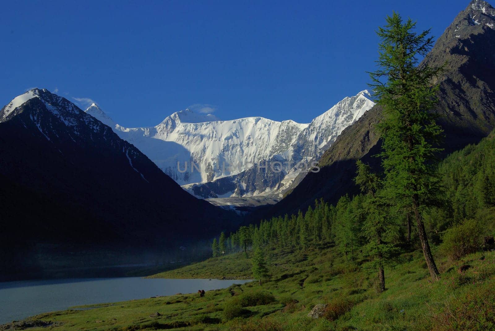 Beautiful mountain landscape near the lake. Mountain Lake. Kind of mountainous terrain and the water in the valley.