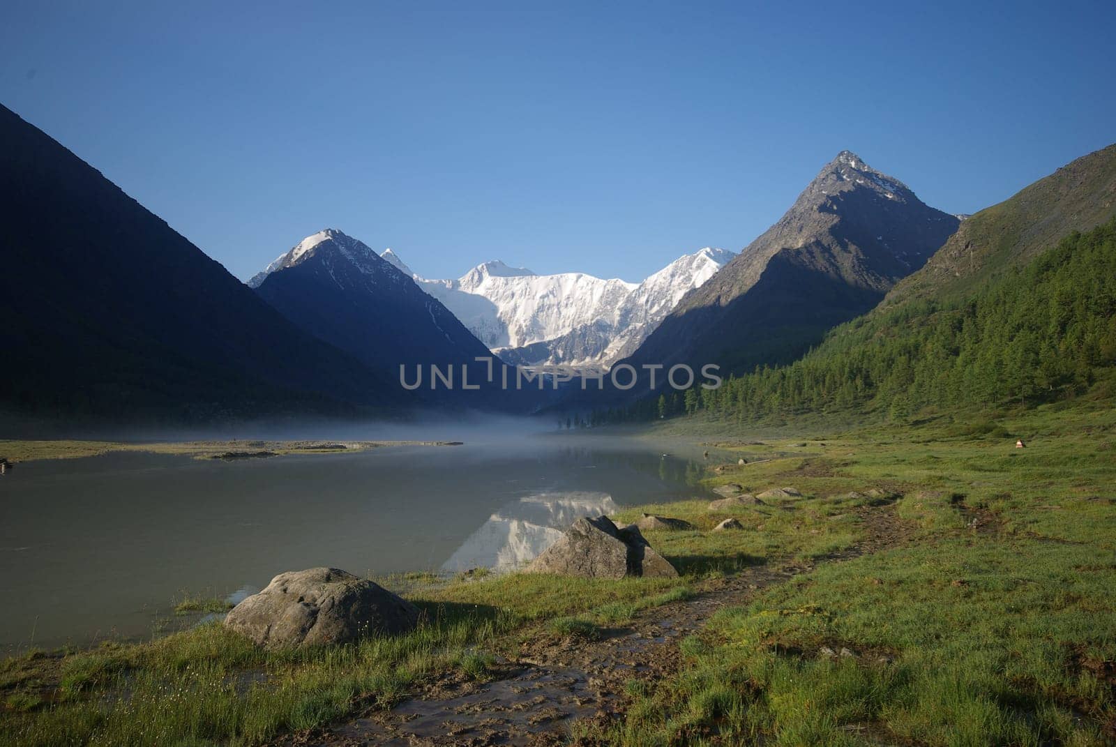 Beautiful mountain landscape near the lake. Mountain Lake. Kind of mountainous terrain and the water in the valley.
