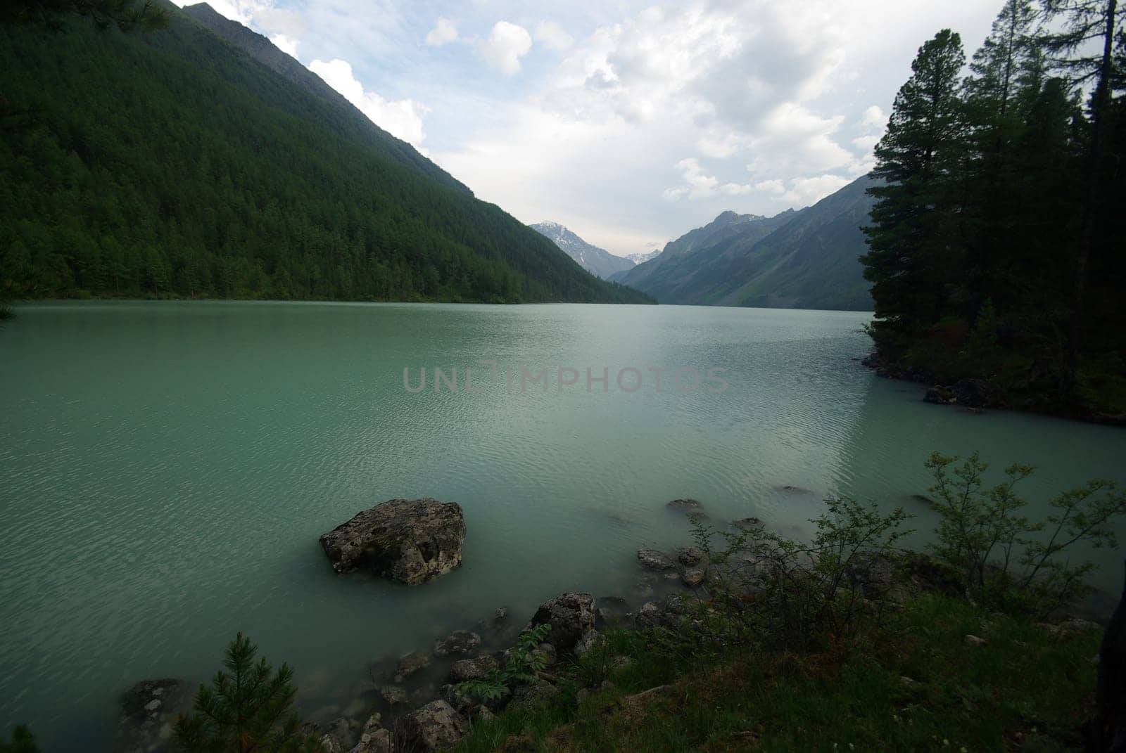 Beautiful mountain landscape near the lake. Mountain Lake. Kind of mountainous terrain and the water in the valley.