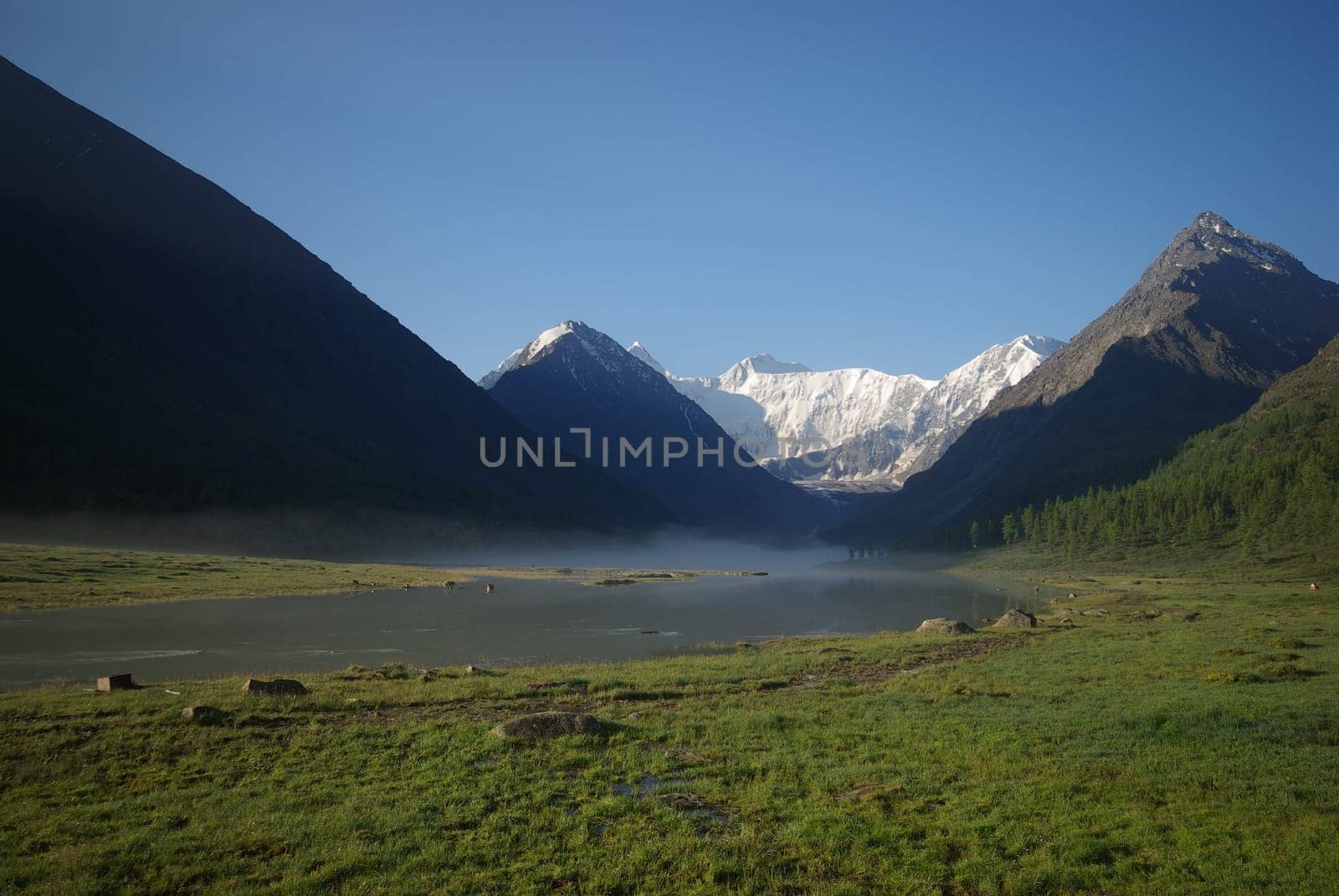 Beautiful mountain landscape near the lake. Mountain Lake. Kind of mountainous terrain and the water in the valley.