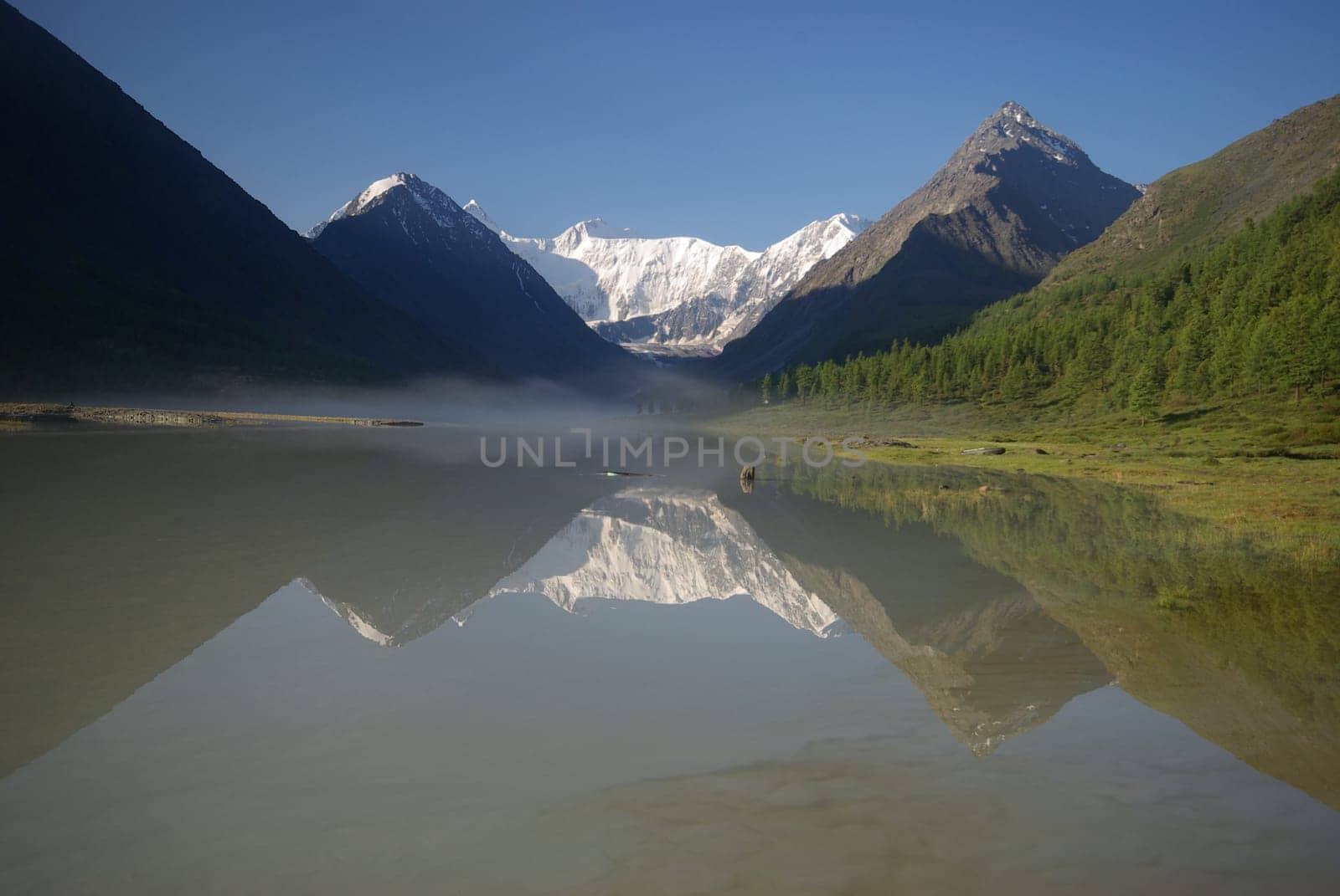Beautiful mountain landscape near the lake. Mountain Lake. Kind of mountainous terrain and the water in the valley.