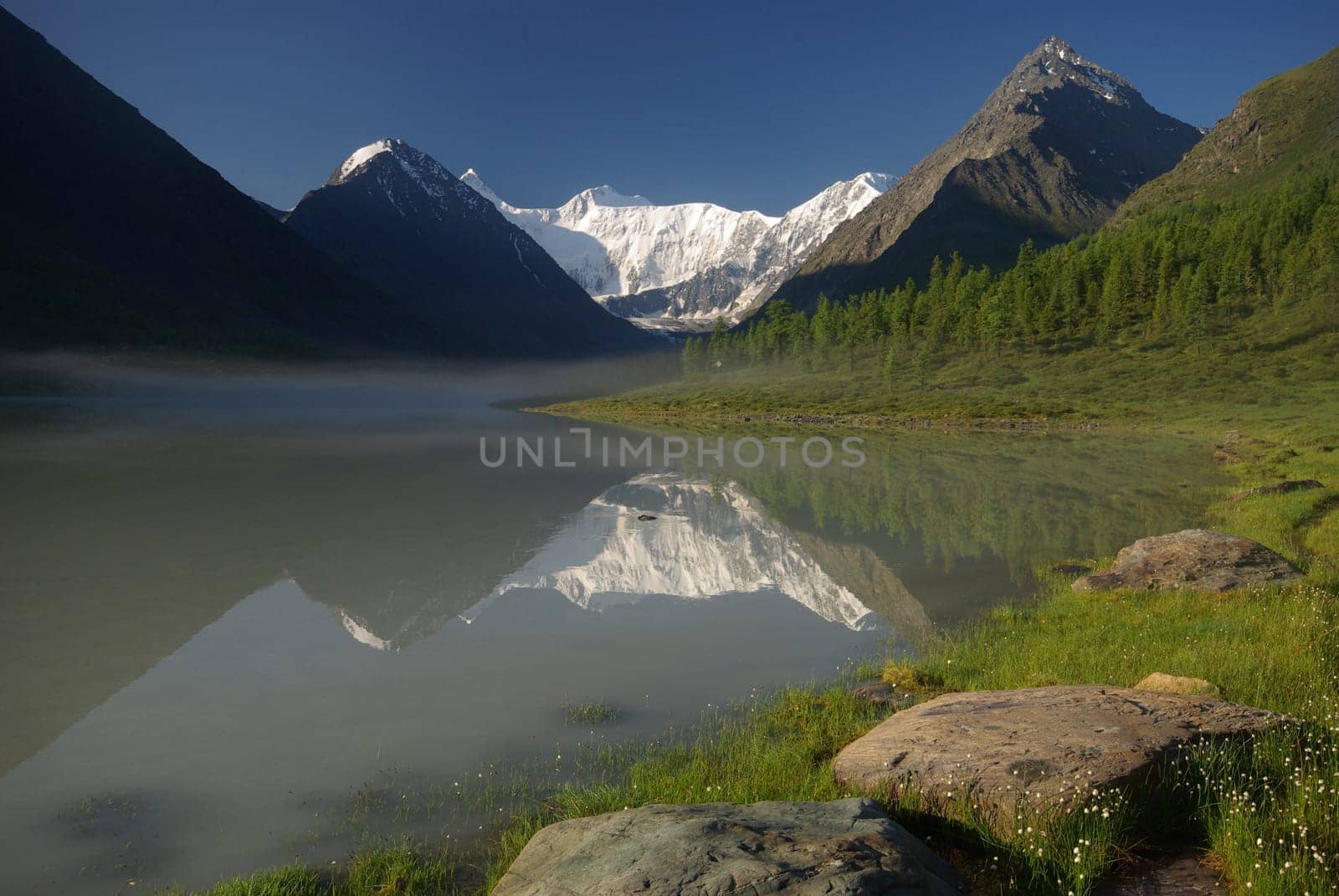 Beautiful mountain landscape near the lake. Mountain Lake. Kind of mountainous terrain and the water in the valley.