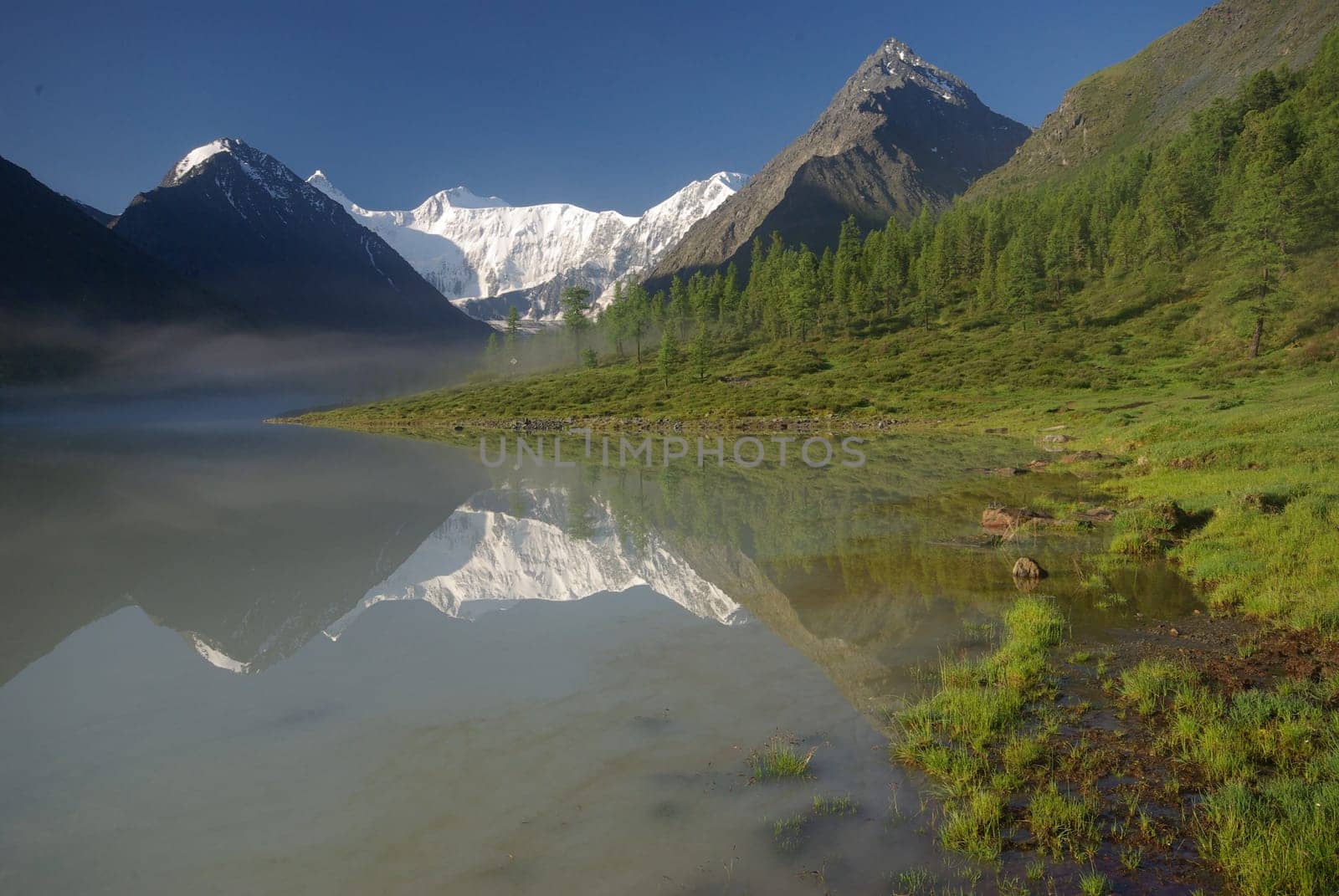 Beautiful mountain landscape near the lake. Mountain Lake. Kind of mountainous terrain and the water in the valley.