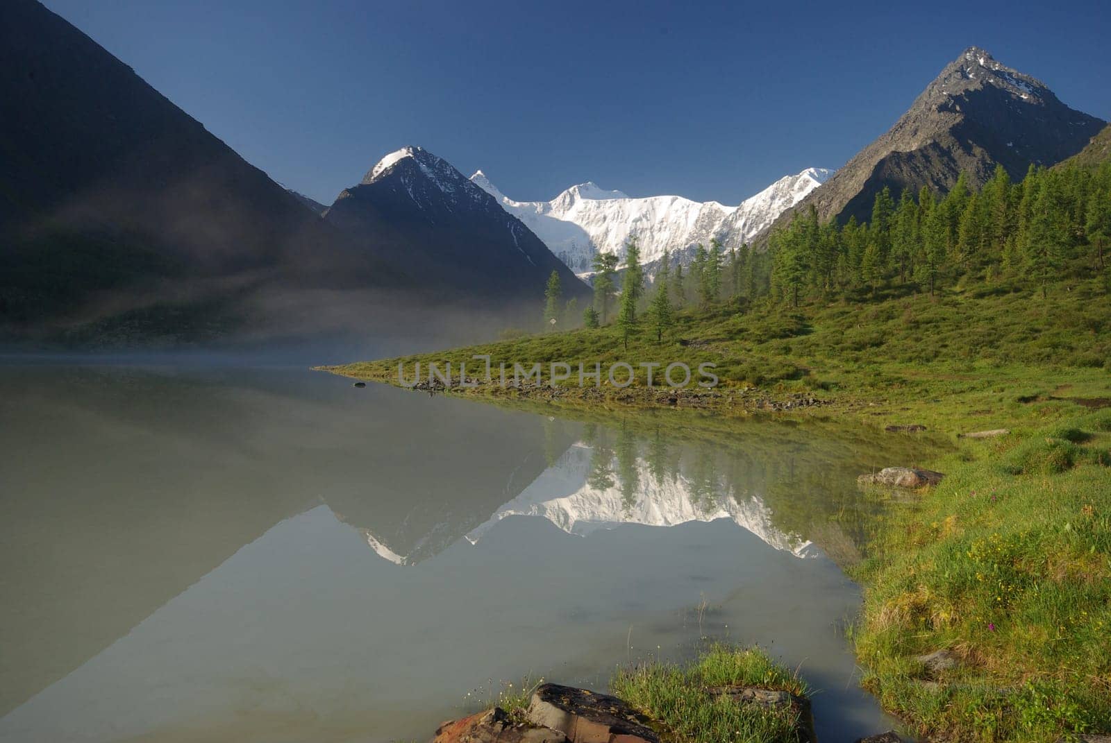 Beautiful mountain landscape near the lake. Mountain Lake. Kind of mountainous terrain and the water in the valley.