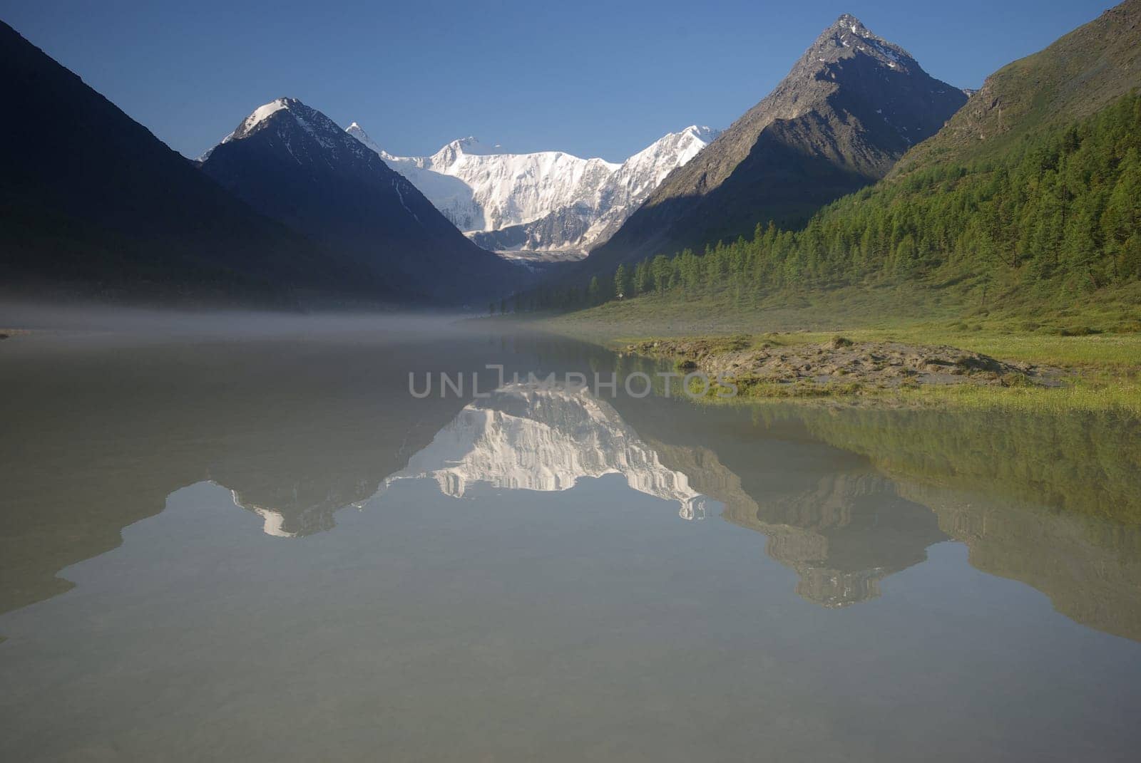 Beautiful mountain landscape near the lake. Mountain Lake. Kind of mountainous terrain and the water in the valley.