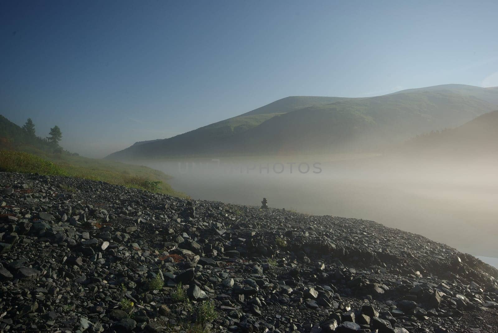 Beautiful mountain landscape near the lake. Mountain Lake. Kind of mountainous terrain and the water in the valley.
