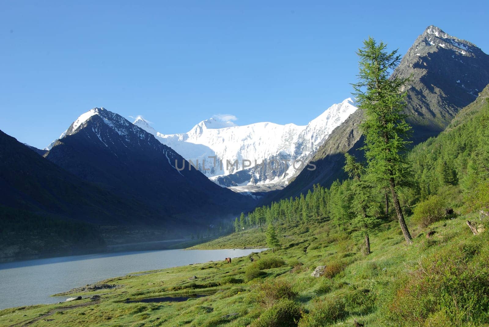 Beautiful mountain landscape near the lake. Mountain Lake. Kind of mountainous terrain and the water in the valley.