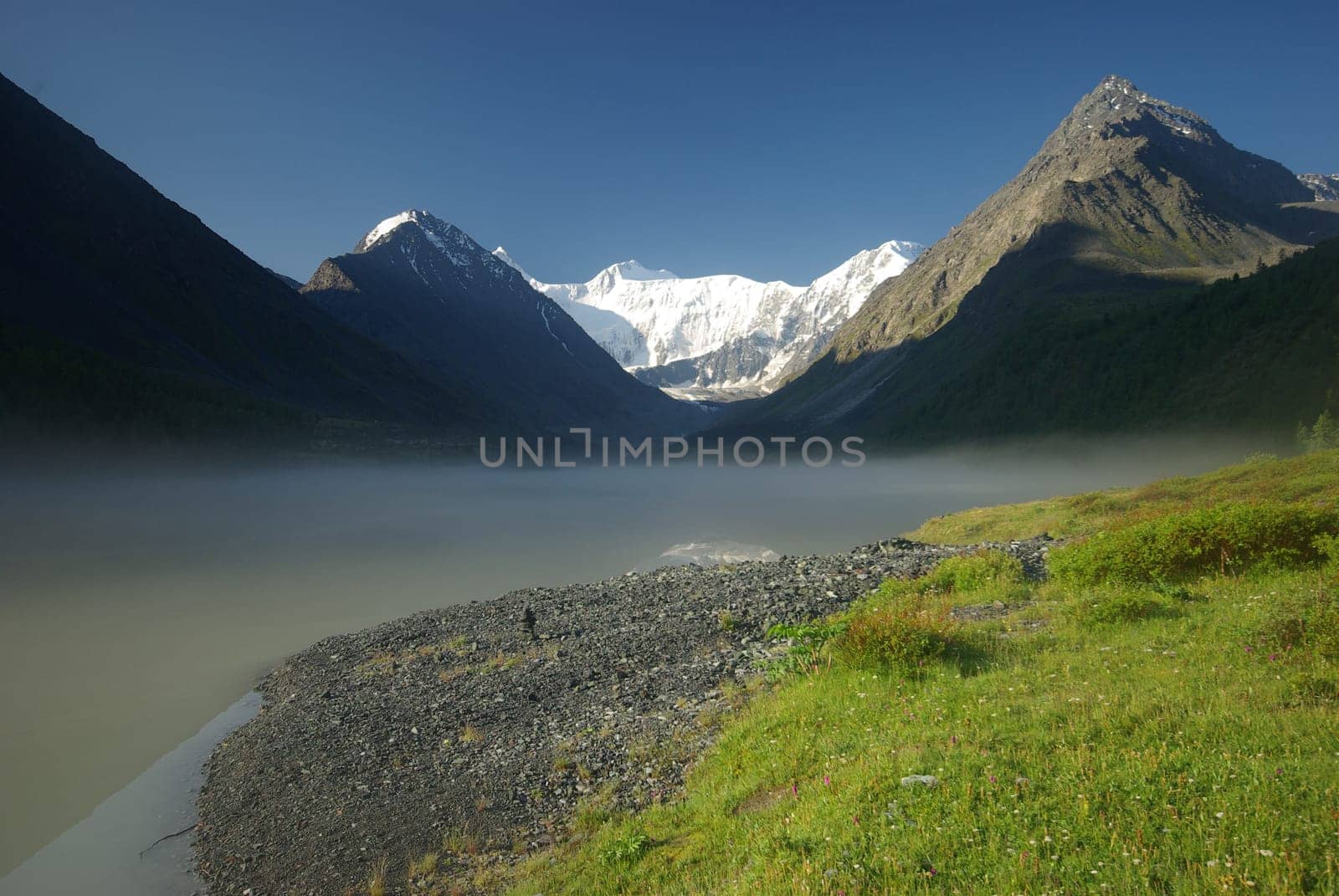 Beautiful mountain landscape near the lake. Mountain Lake. Kind of mountainous terrain and the water in the valley.