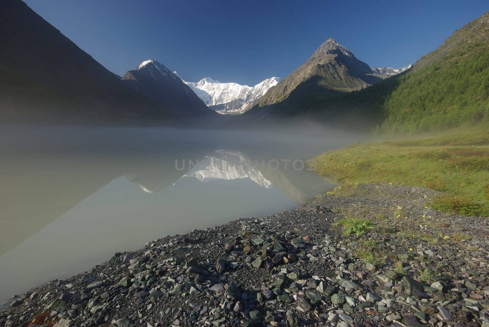 Beautiful mountain landscape near the lake. Mountain Lake. Kind of mountainous terrain and the water in the valley.