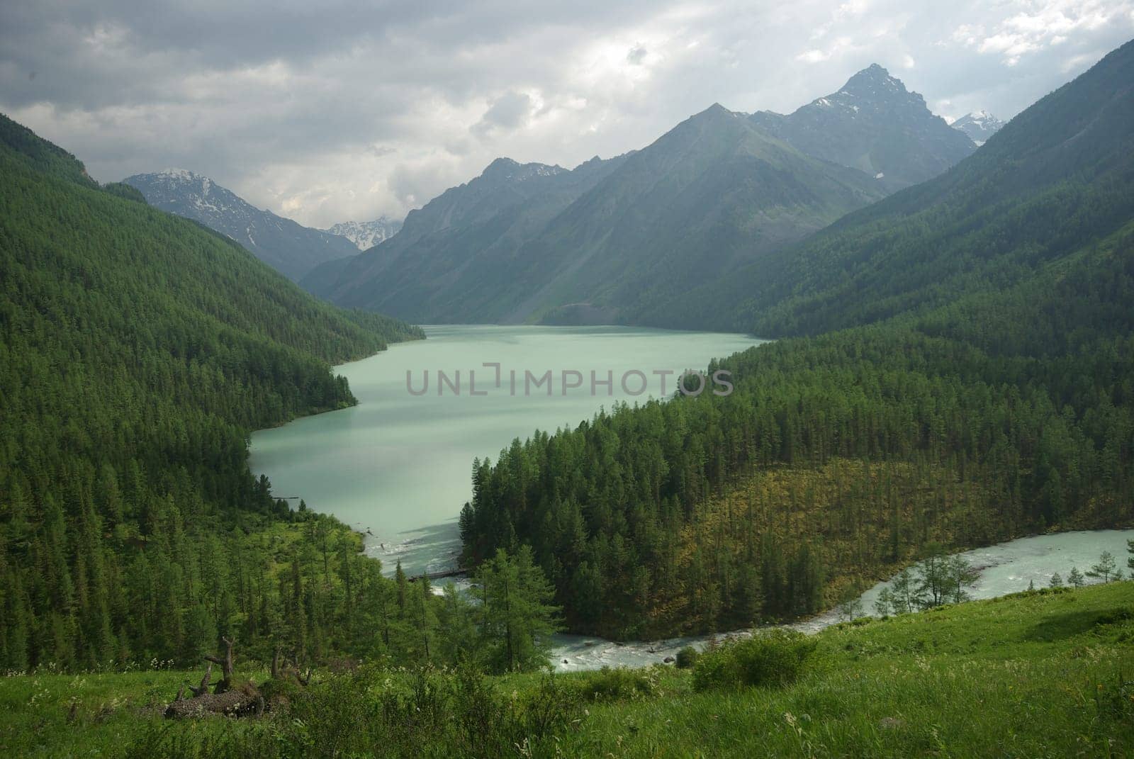 Beautiful mountain landscape near the lake. Mountain Lake. Kind of mountainous terrain and the water in the valley.
